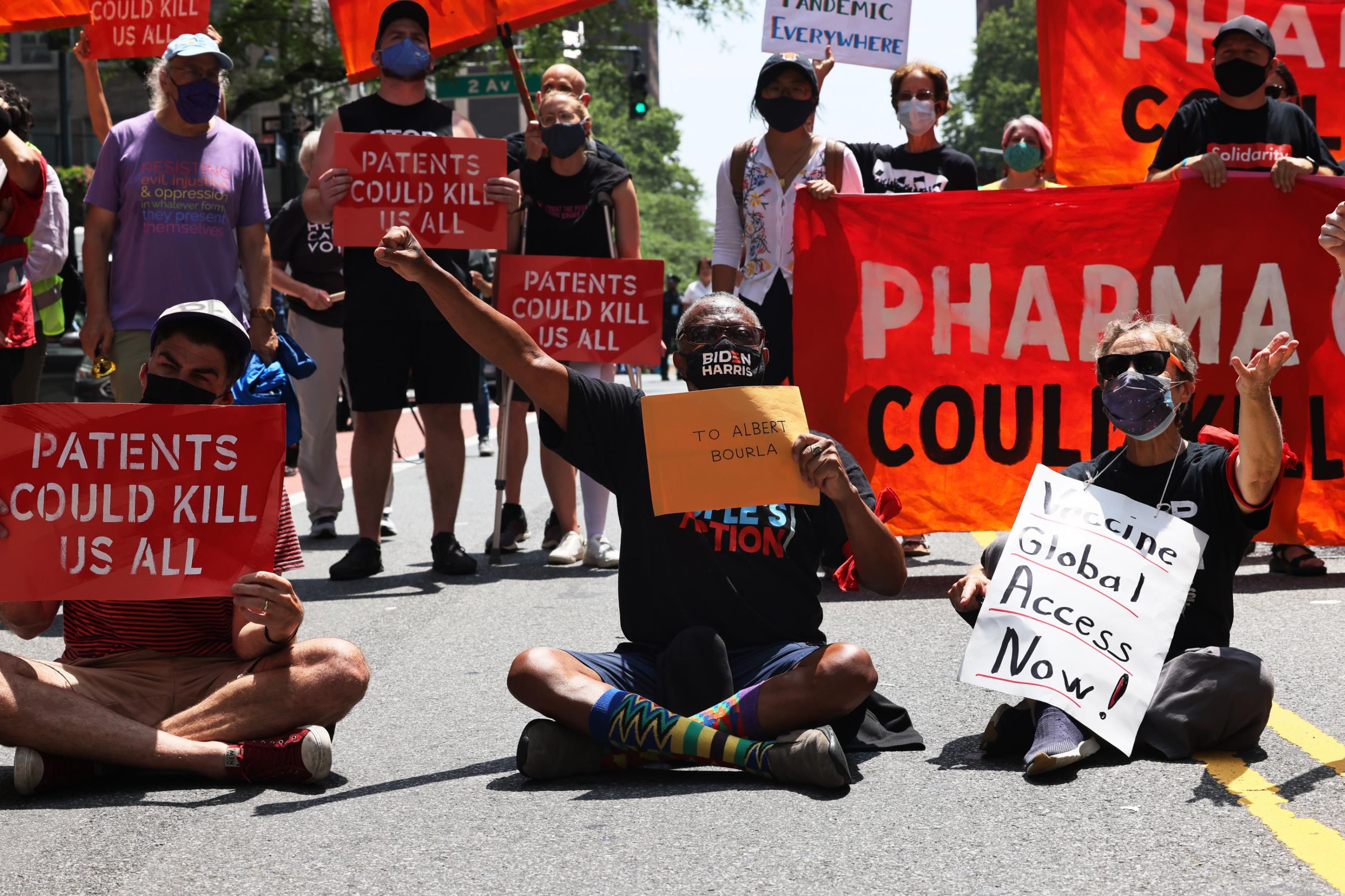 People hold a sit-in during a protest to demand German Chancellor Angela Merkel and Pfizer make Covid-19 vaccines and treatments more accessible outside the pharmaceutical company's headquarters on July 14, 2021 in New York City. (Photo: Michael M. Santiago via Getty Images)