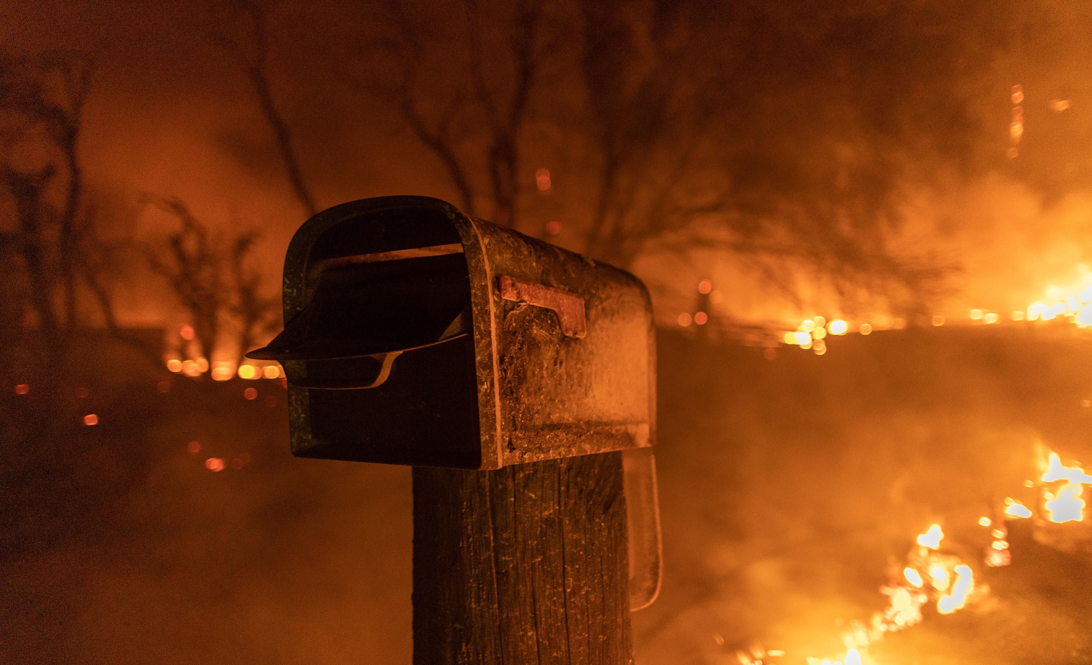Mailbox standing as the fires burn