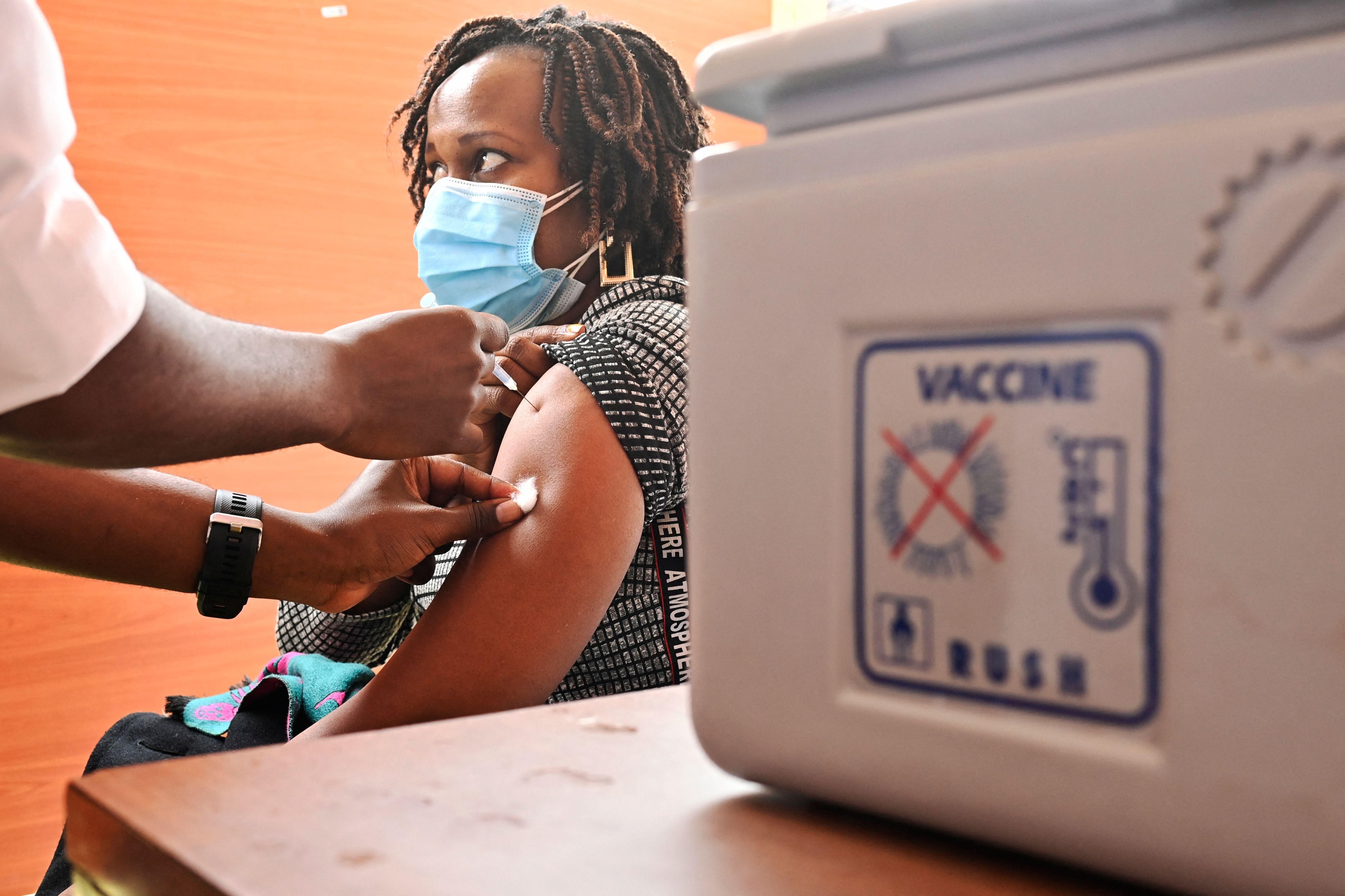 A Kenyan woman receives an injection