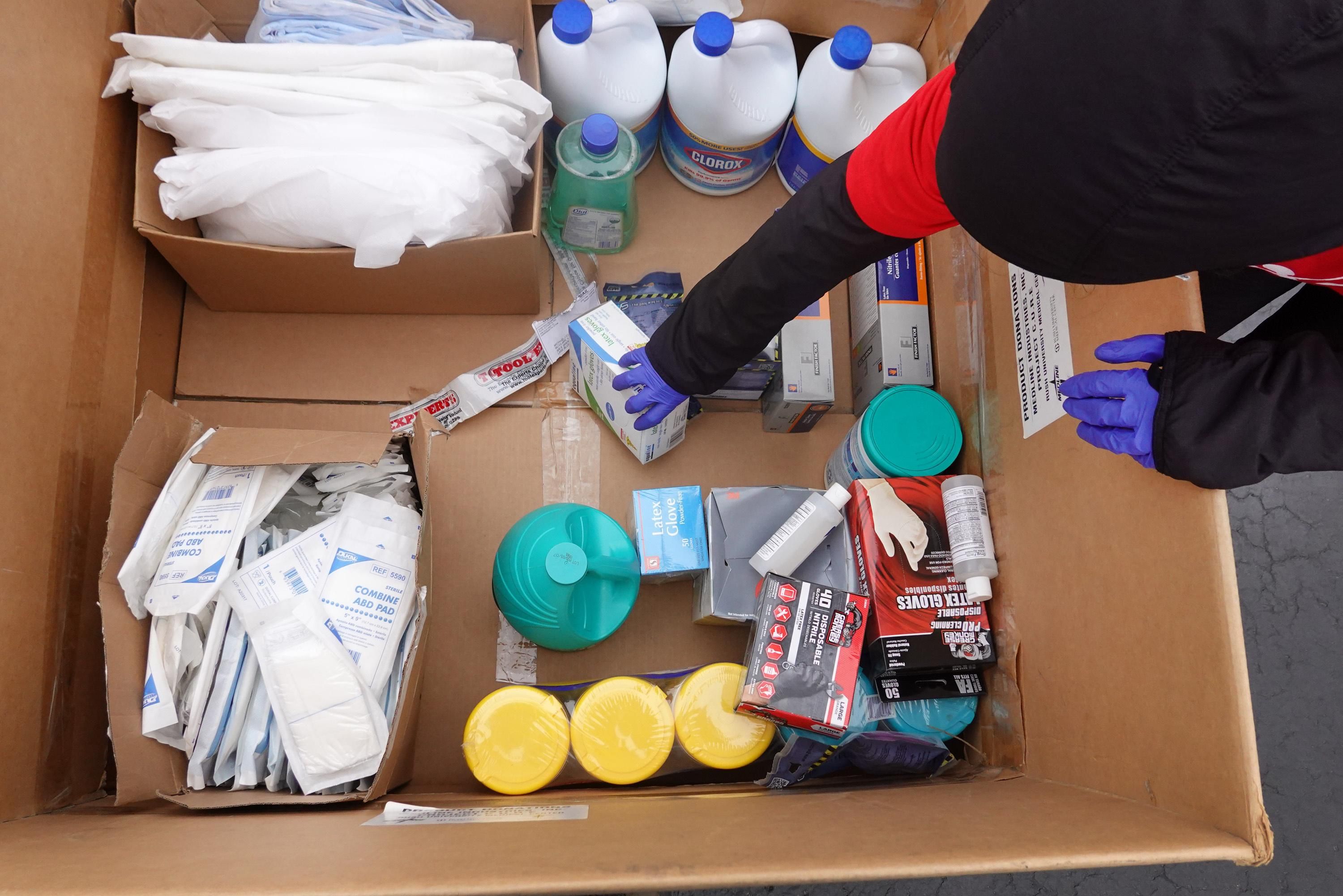 Staff and volunteers with Project C.U.R.E hold a drive outside the United Center to collect donations of personal protective equipment from the community which will be used to supply hospitals and clinics that are experiencing shortages due to the Covid-19 pandemic on March 29, 2020 in Chicago. (Photo: Scott Olson via Getty Images)