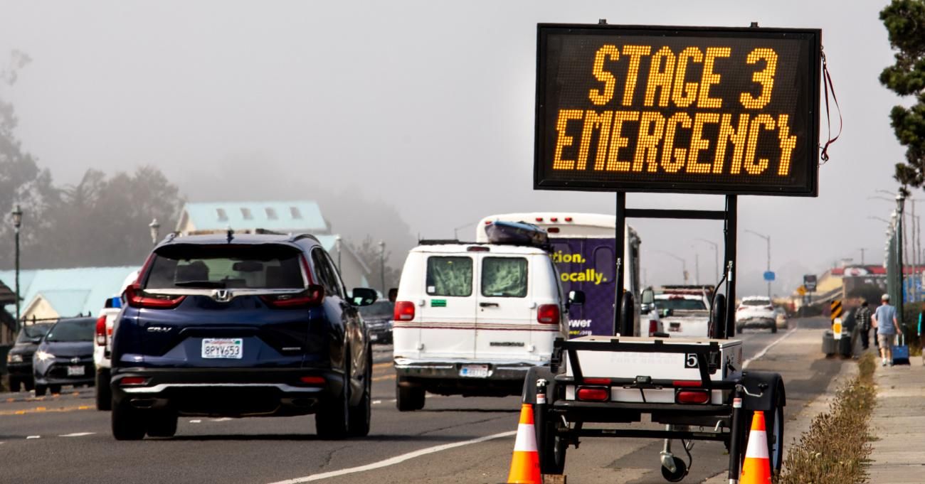 A "Stage 3 Emergency' sign is seen on a highway