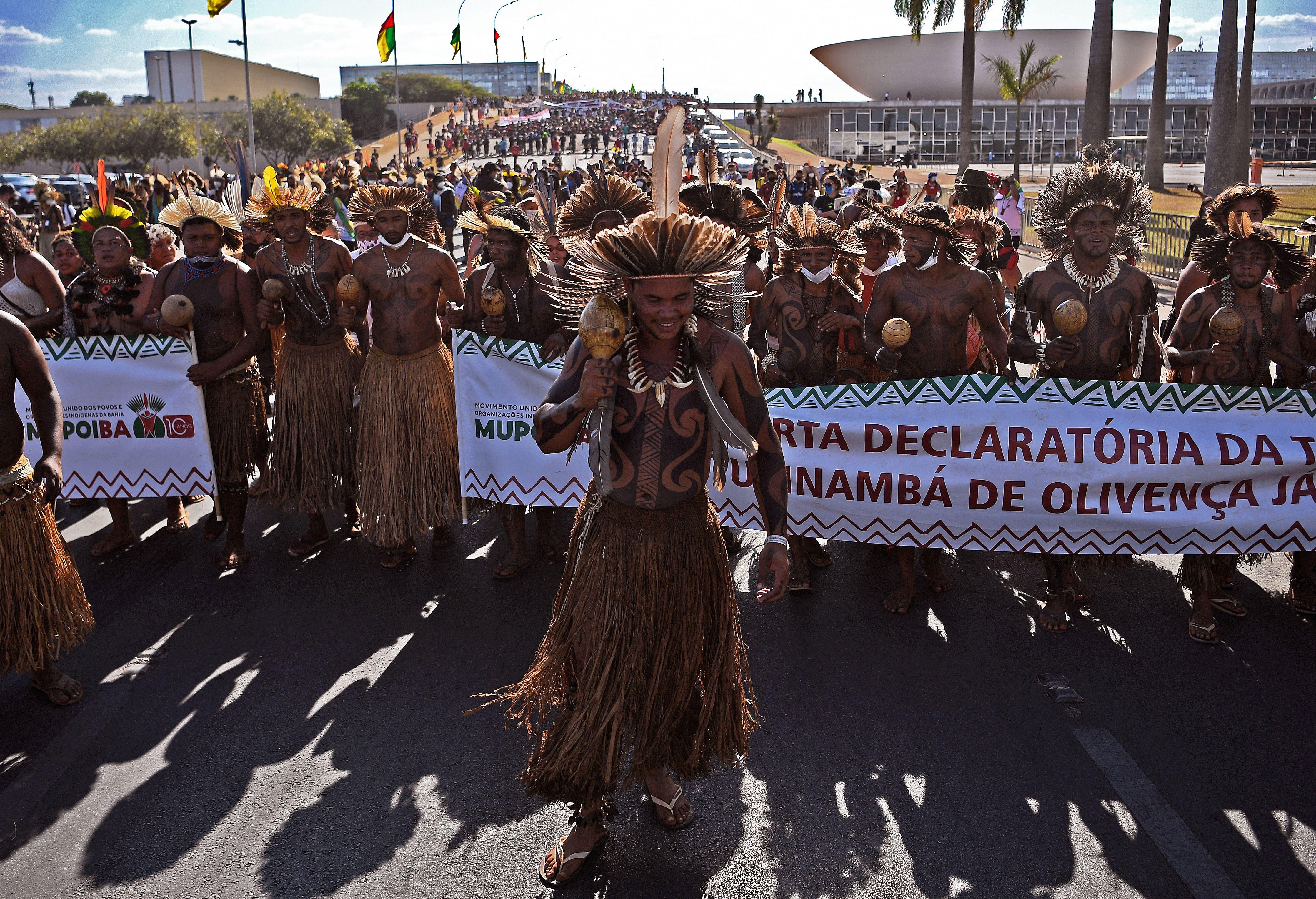 Indigenous protestors march towards the Supreme Court building in Brasilia