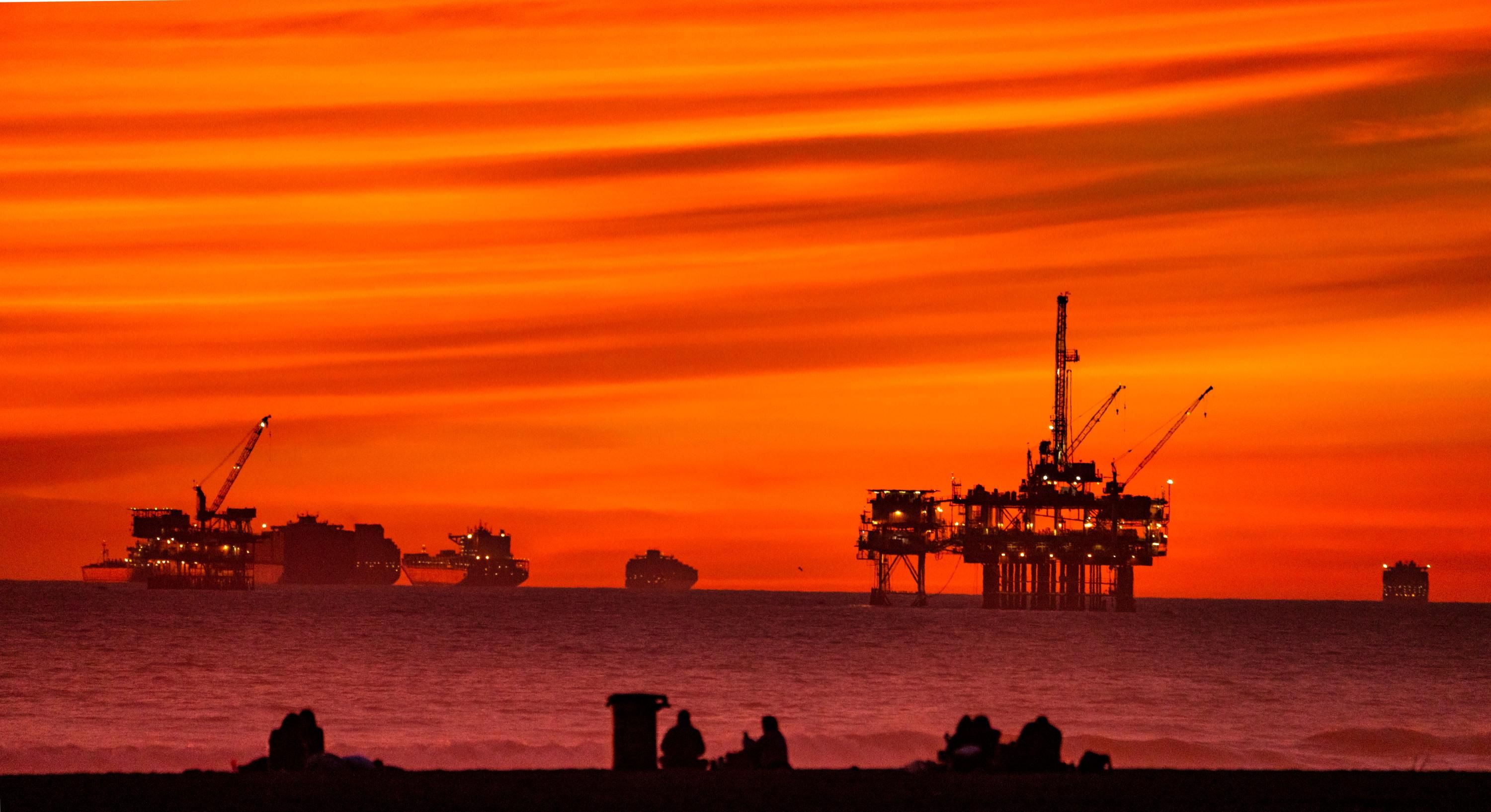 The sun sets over container ships and oil platforms off the coast of Huntington Beach, California on January 12, 2021. (Photo: Leonard Ortiz/MediaNews Group/Orange County Register via Getty Images)
