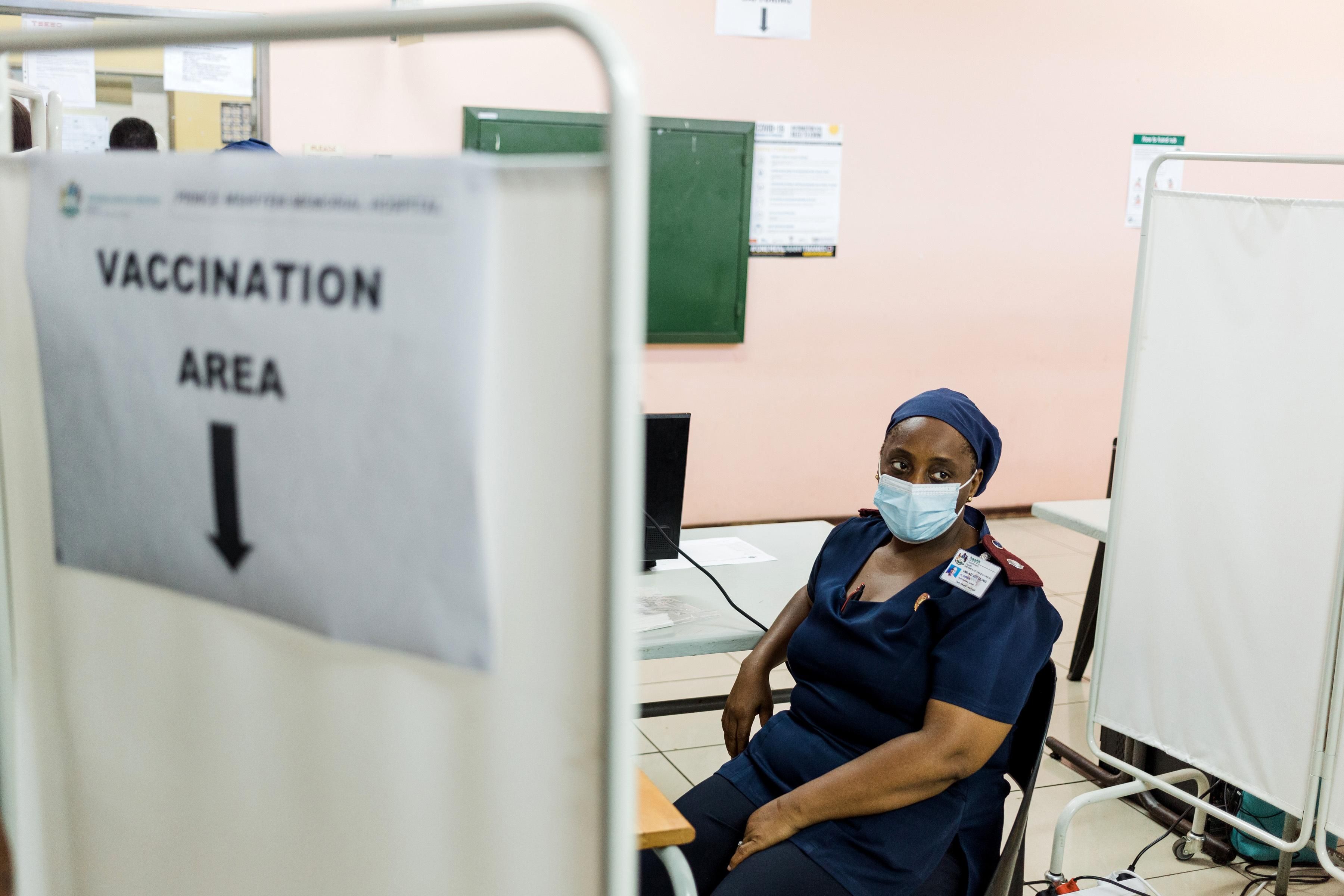 A nurse waits to receive a coronavirus vaccine dose in South Africa