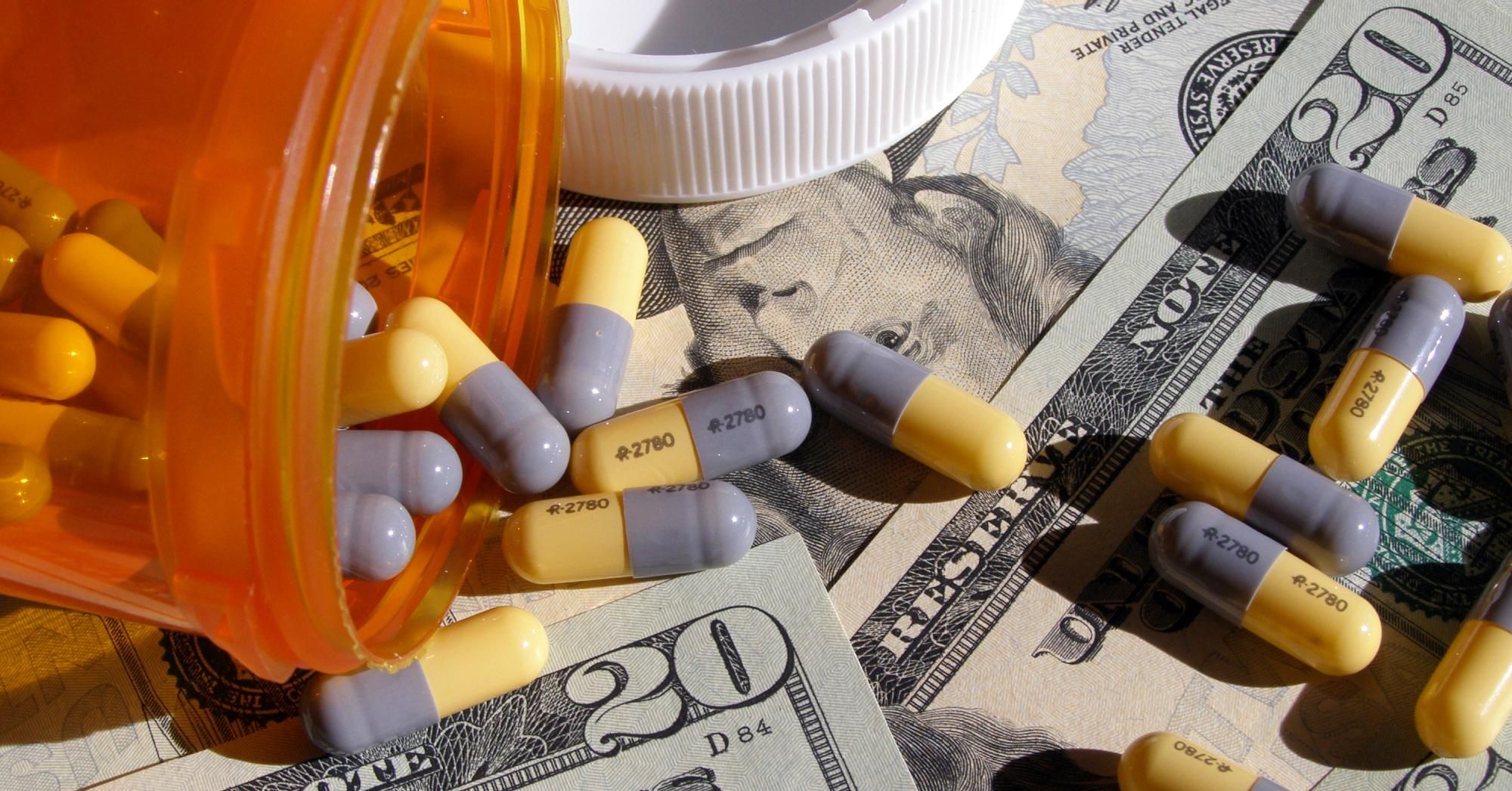 Prescription pills shown with $20 bills.