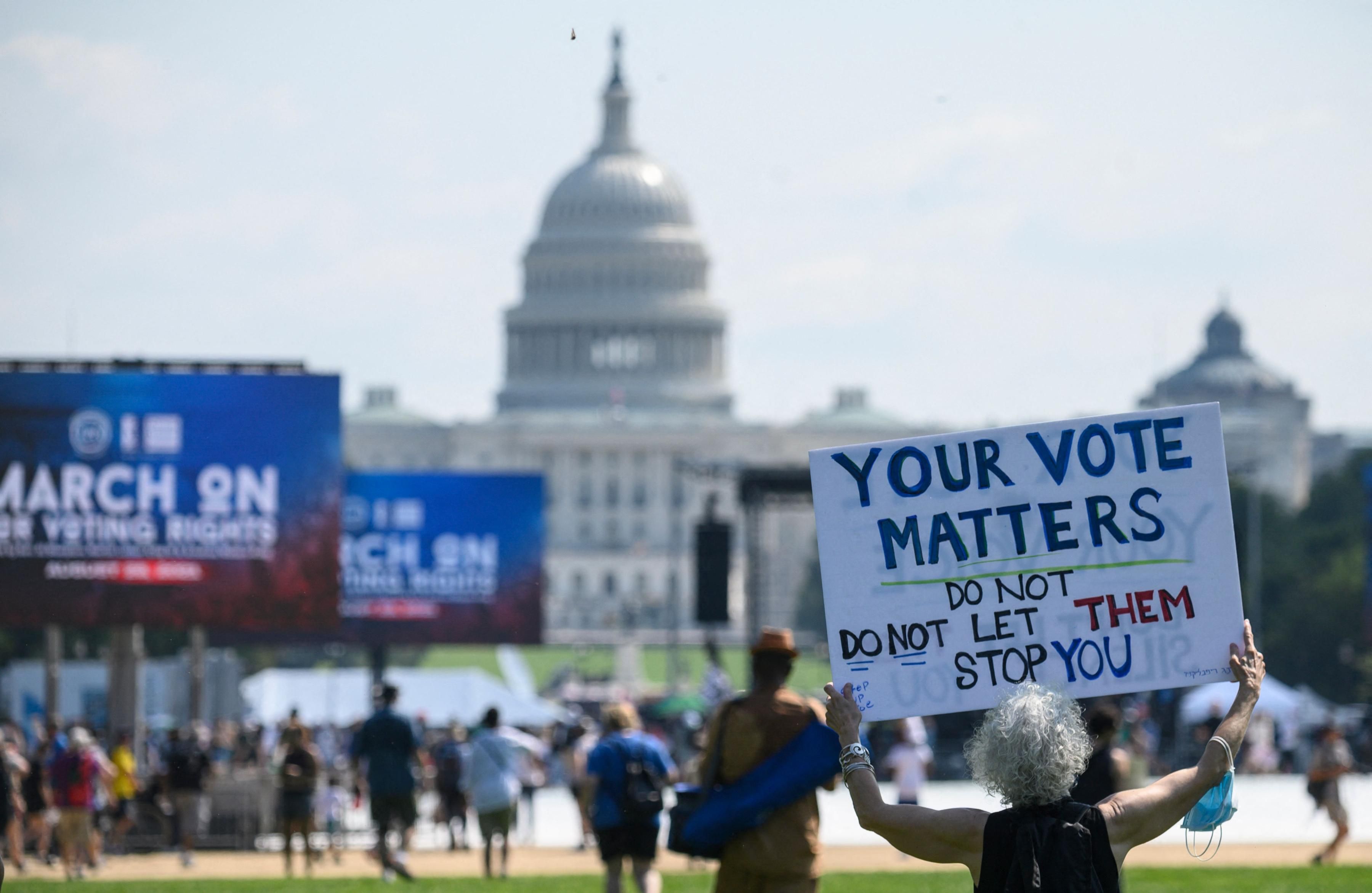 Demonstrators attend a rally for voting rights