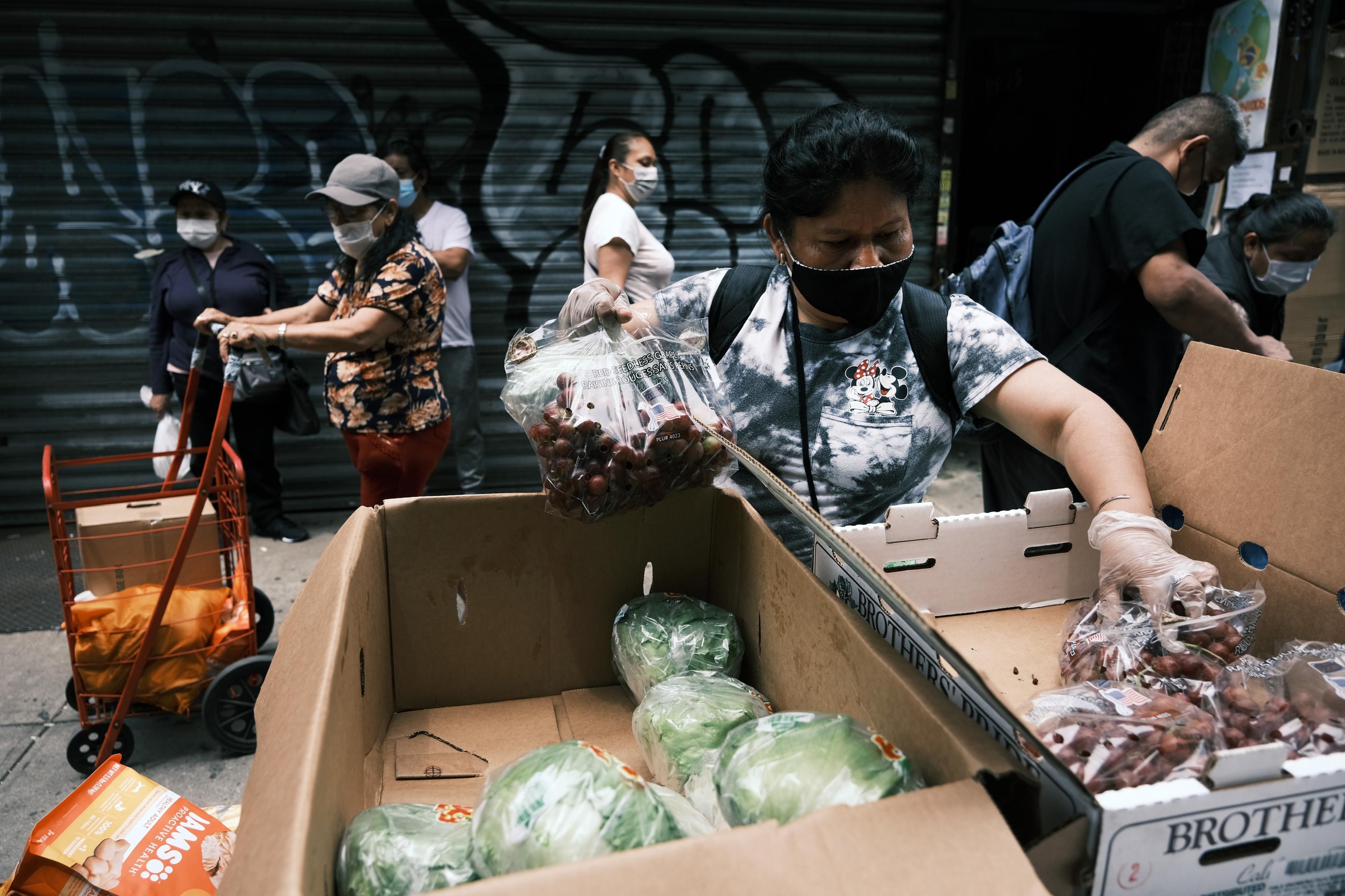 A person picks up food at a charity in New York City