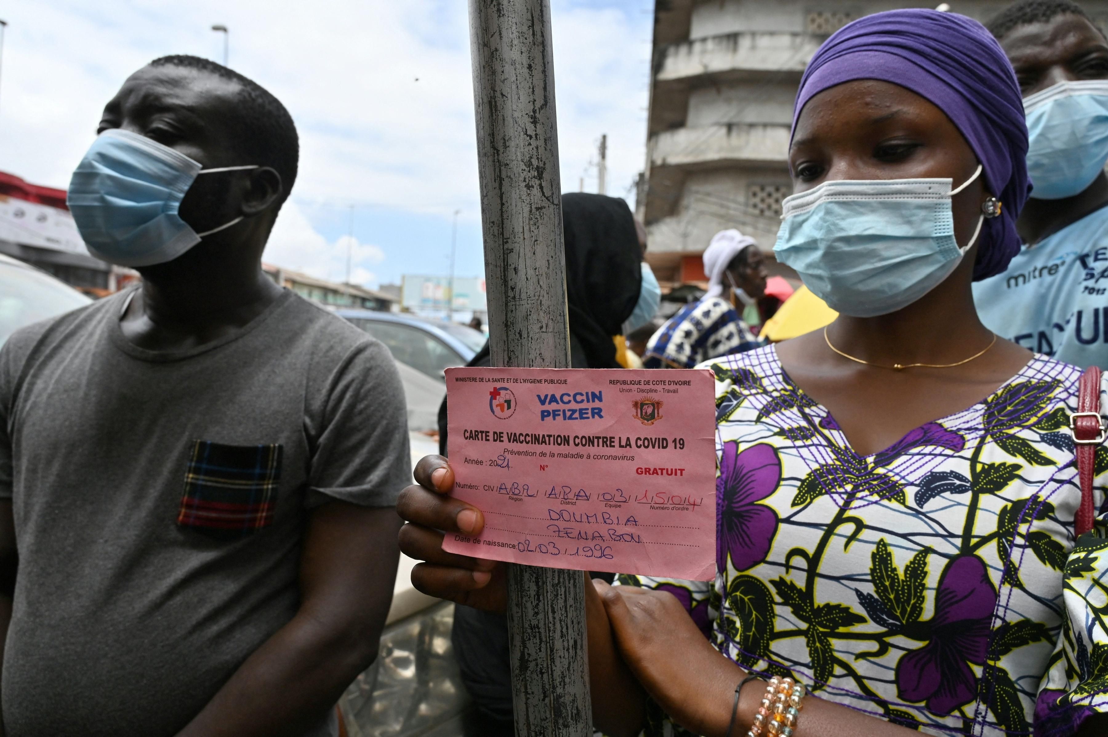 People receive the Pfizer vaccine in West Africa
