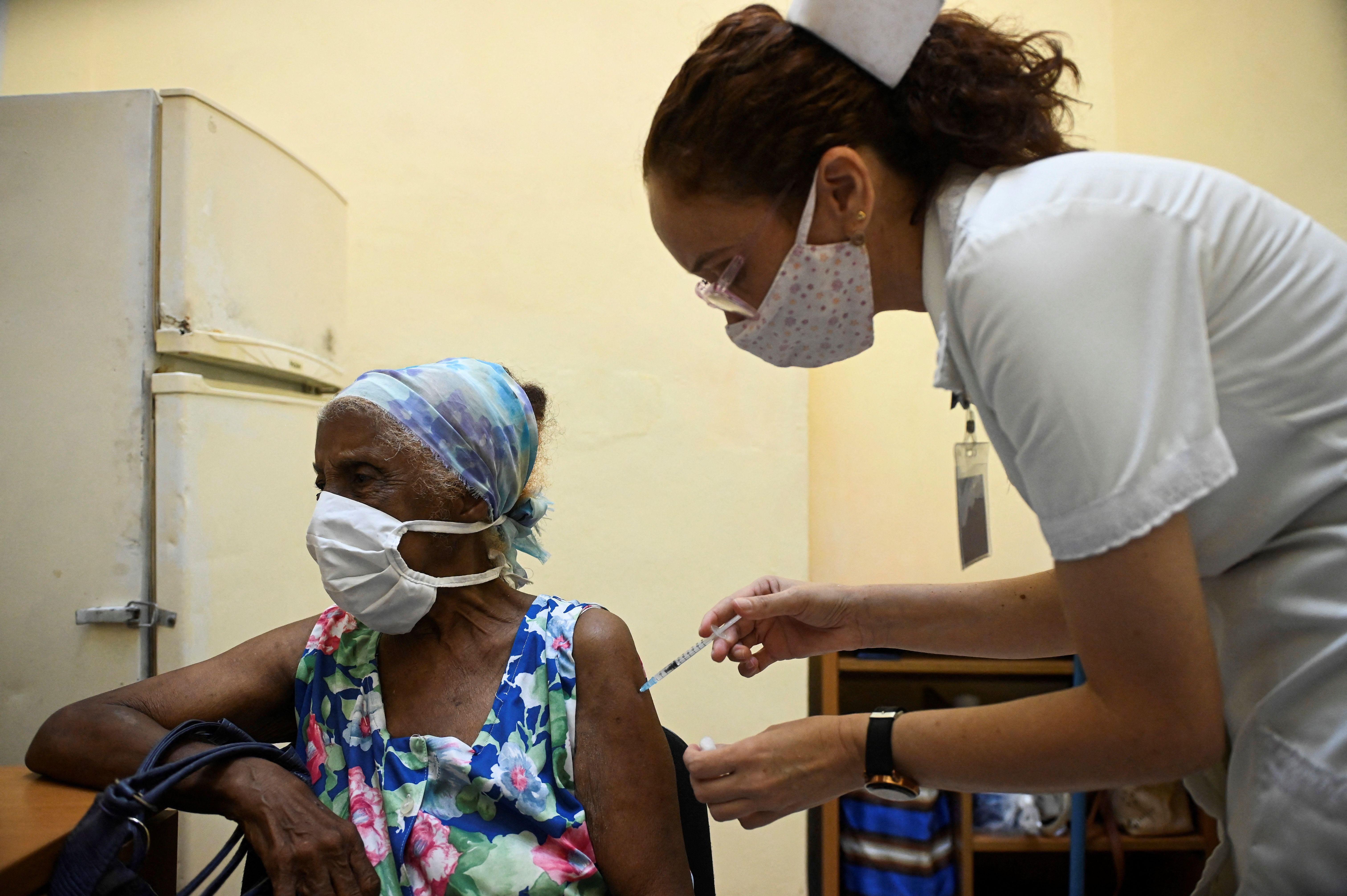 A nurse vaccinates an elderly woman against Covid-19 with Cuban vaccine Abdala in Havana on August 2, 2021