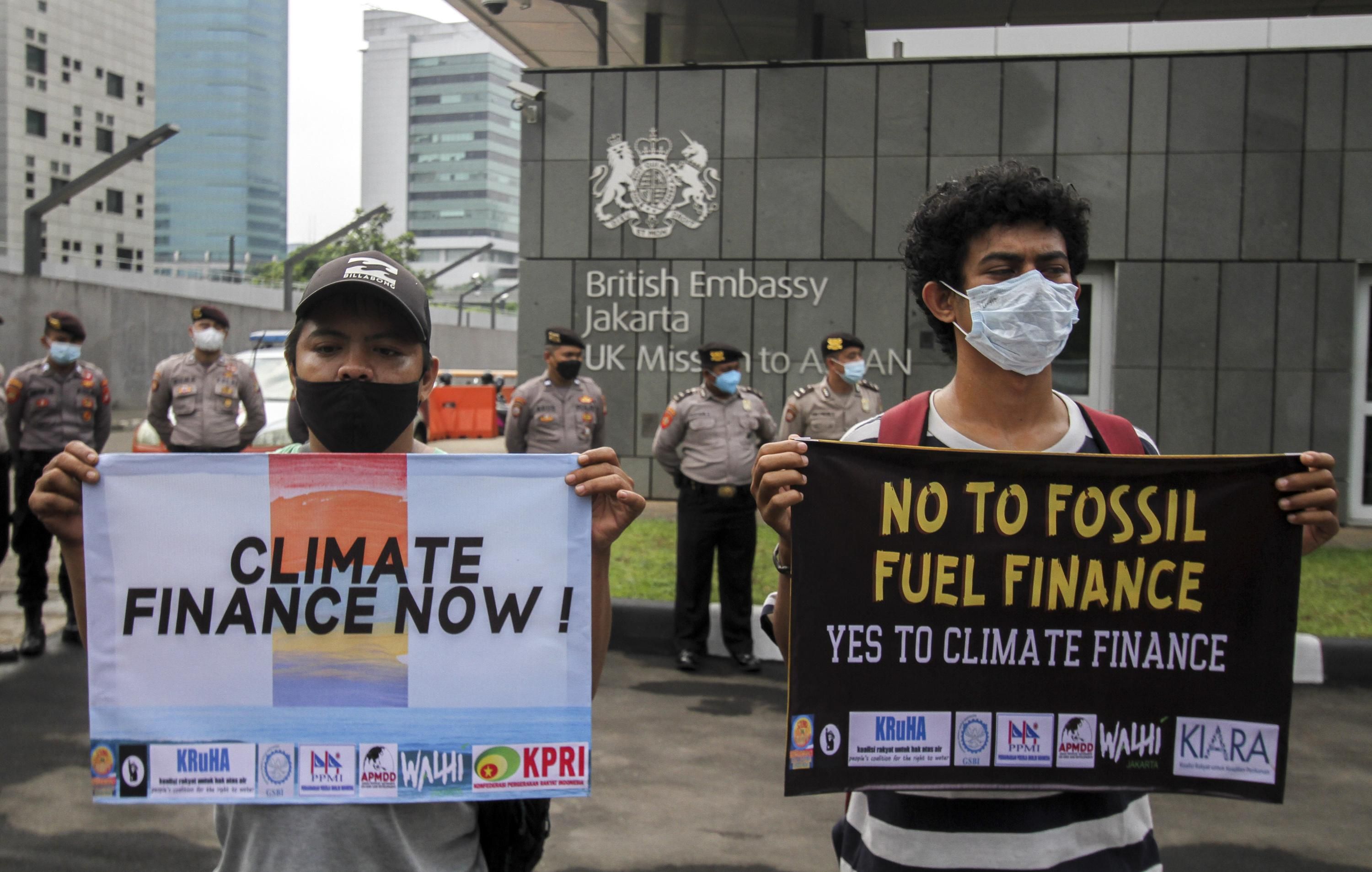 Demonstrators protest fossil fuel funding at the British Embassy in Jakarta.