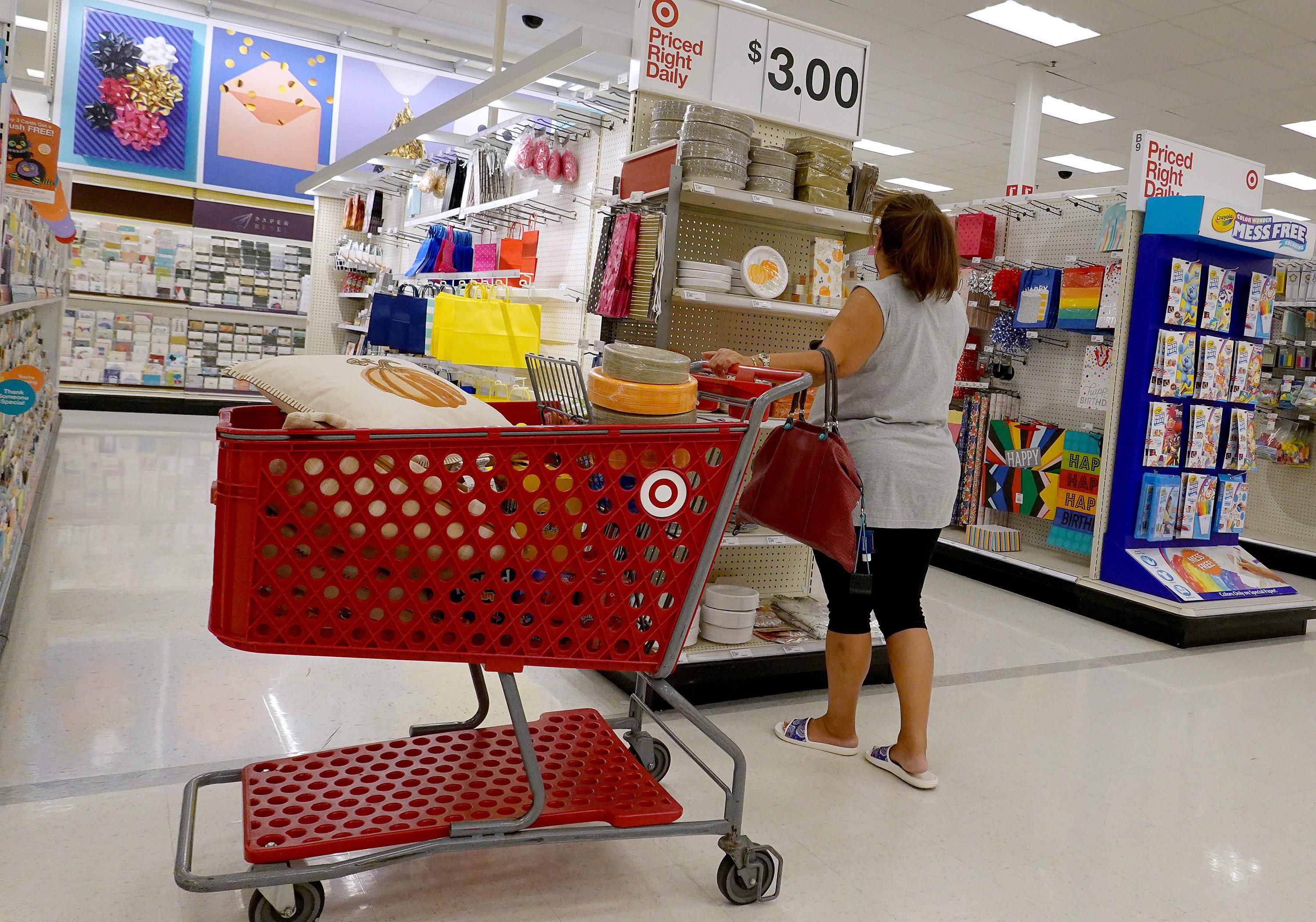 A shopper looks at a price tag at Target.