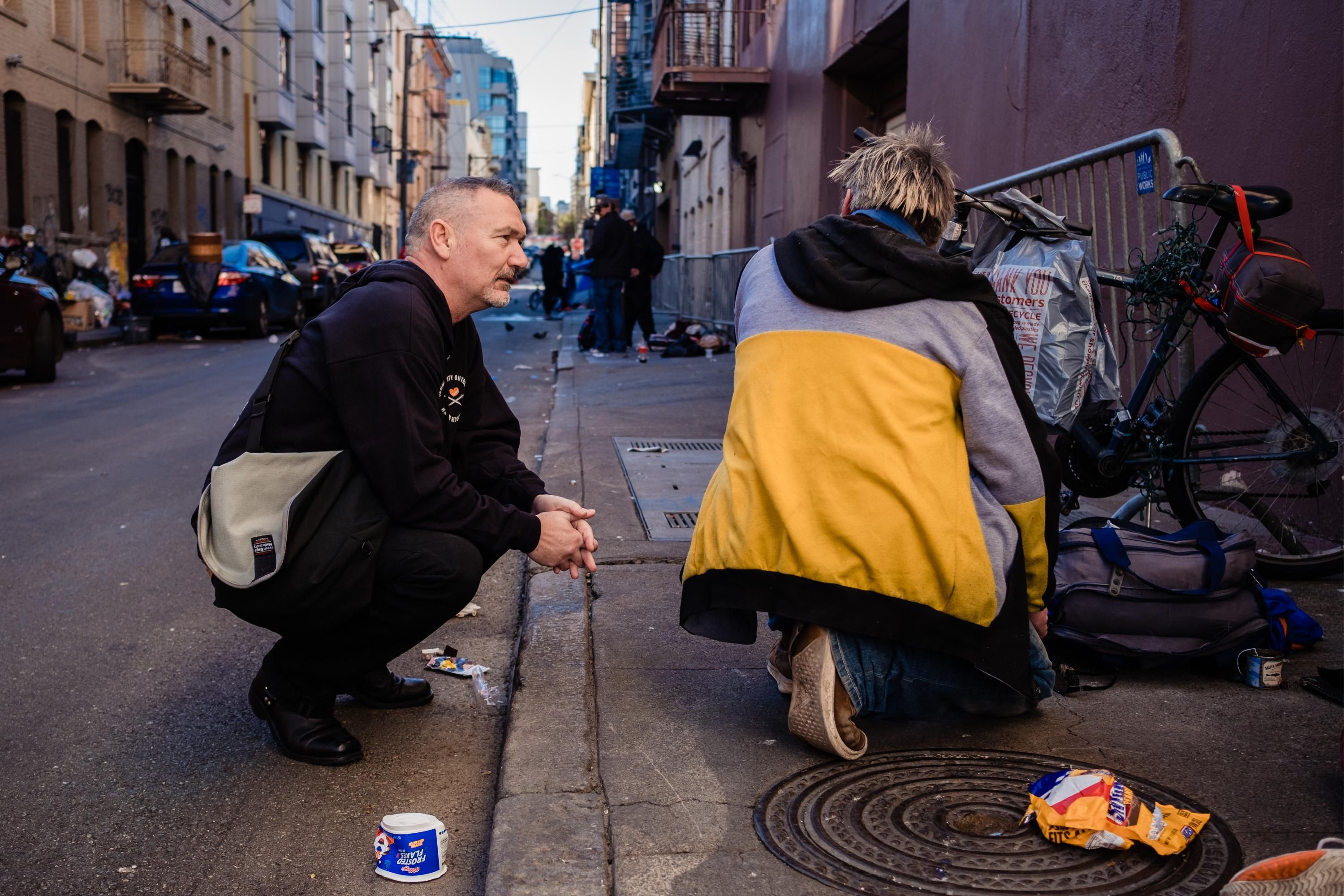 A harm reduction worker speaks to a person on the streets of San Francisco
