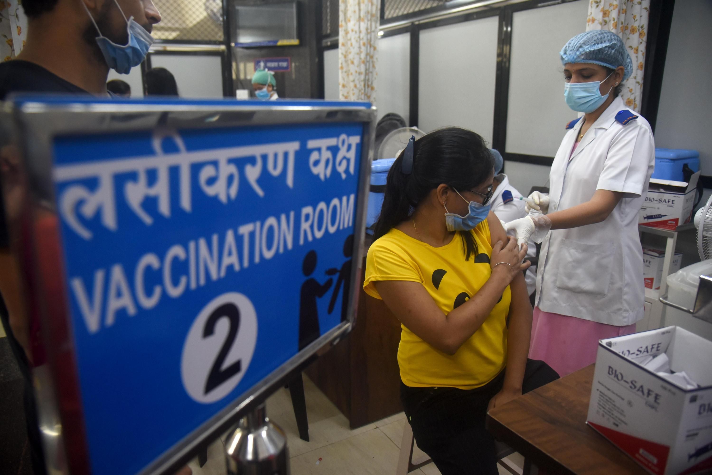 People receive coronavirus vaccines in Mumbai, India