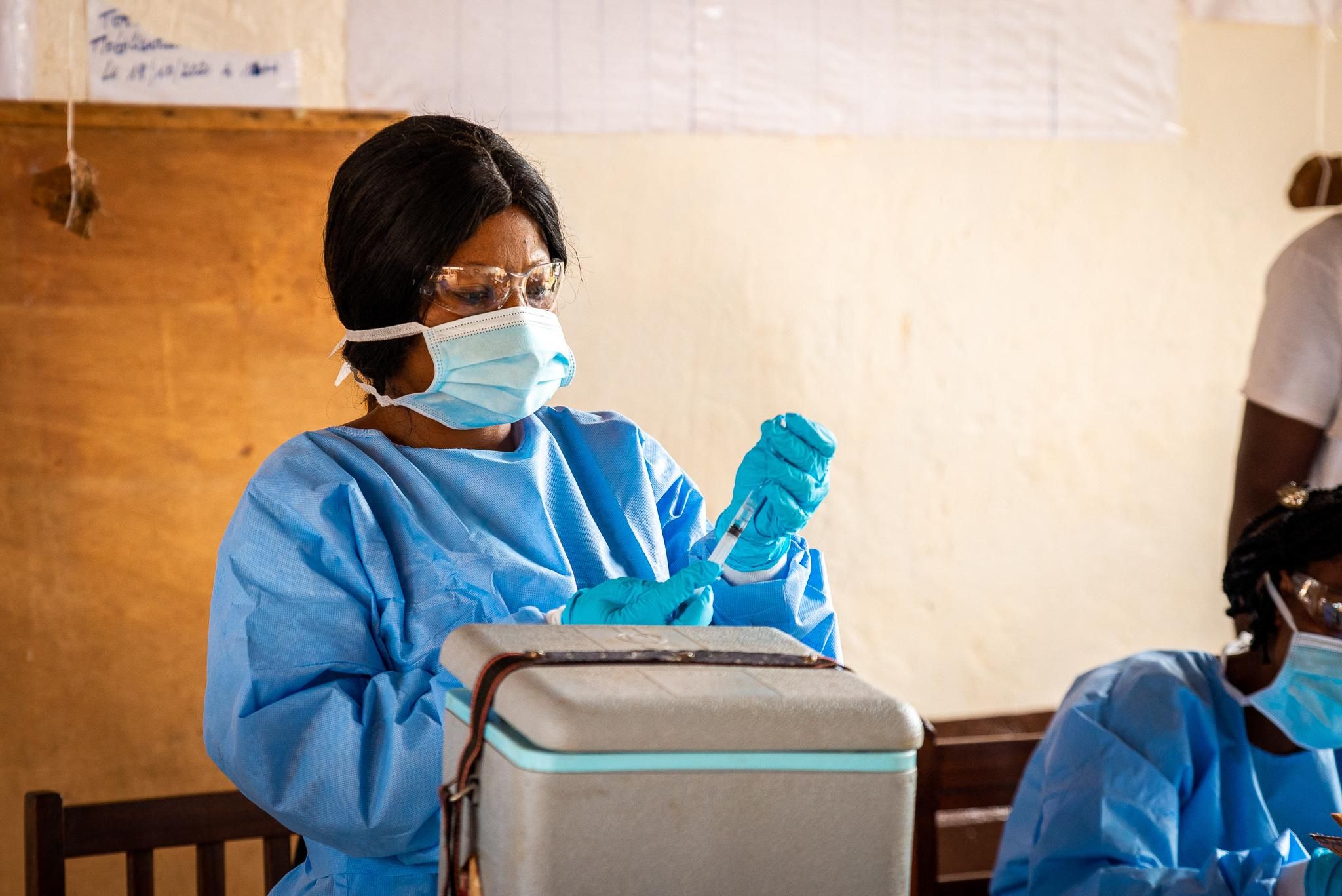 A healthcare worker prepares a coronavirus vaccine dose.