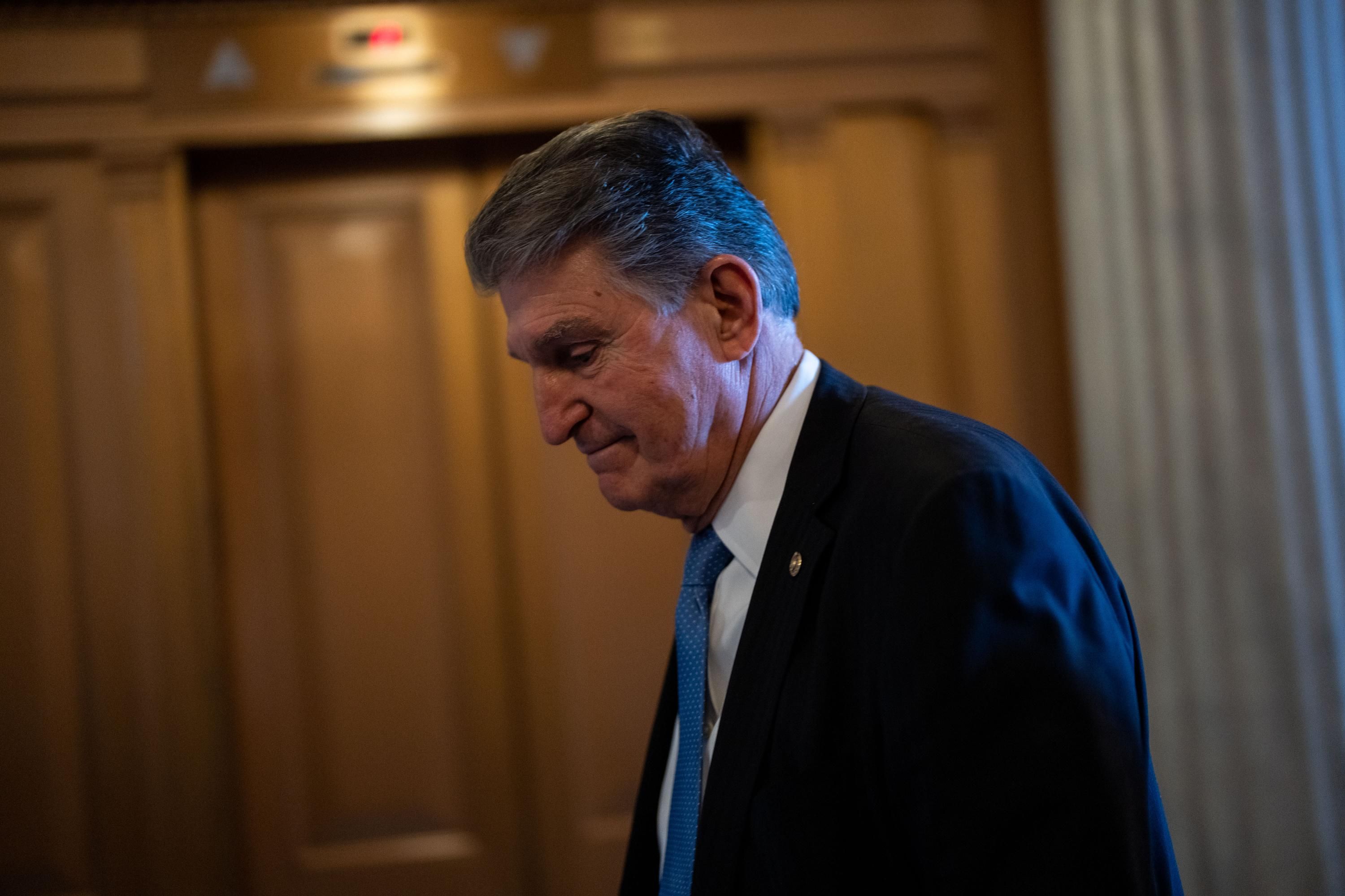 Sen. Joe Manchin walks in the Capitol hallway