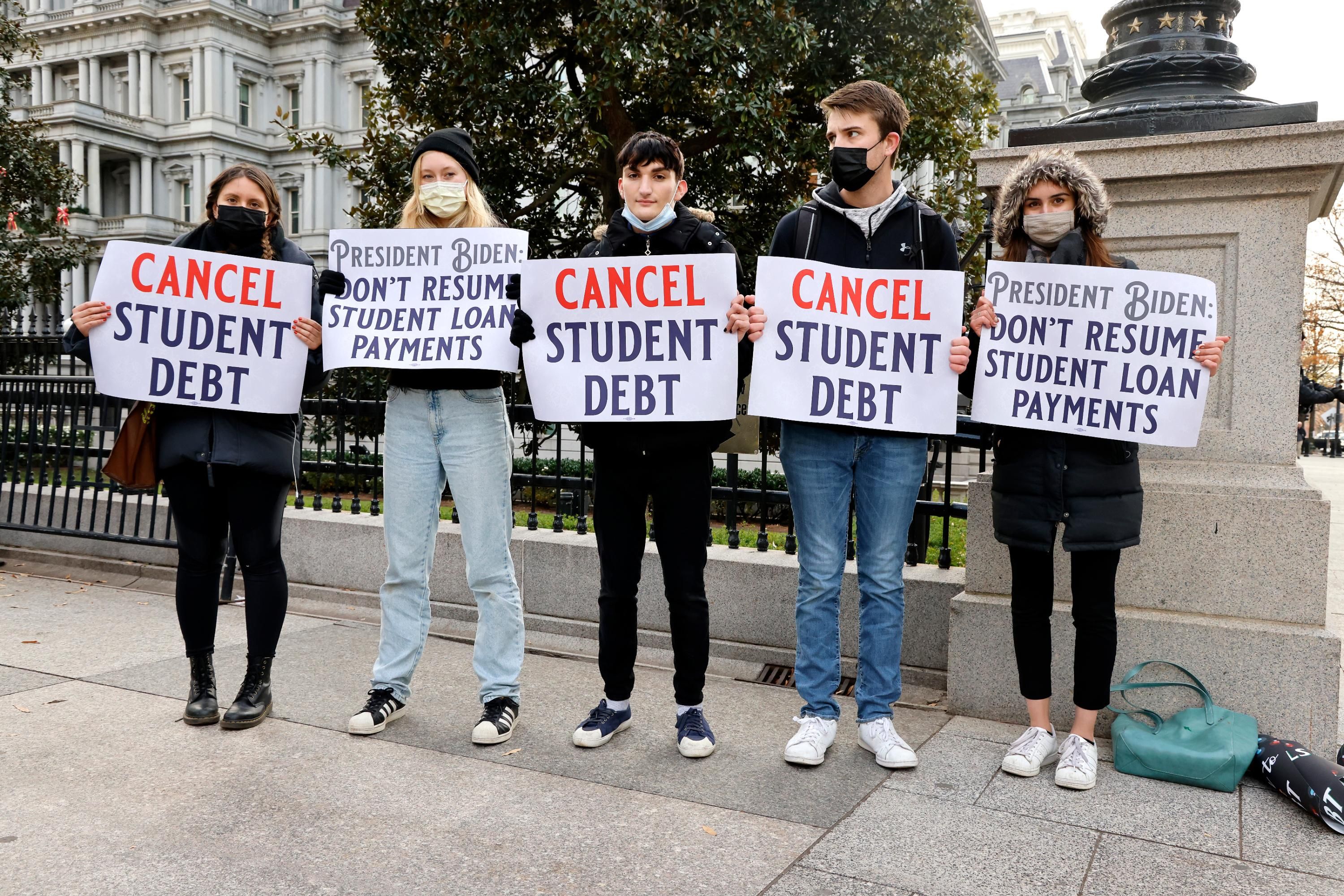 Demonstrators urge President Joe Biden to cancel student debt.