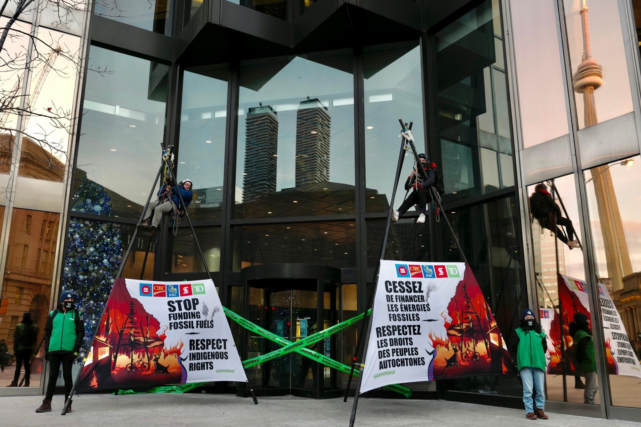 Greenpeace Canada campaigners disrupt business as usual in Toronto's financial district on December 7, 2021