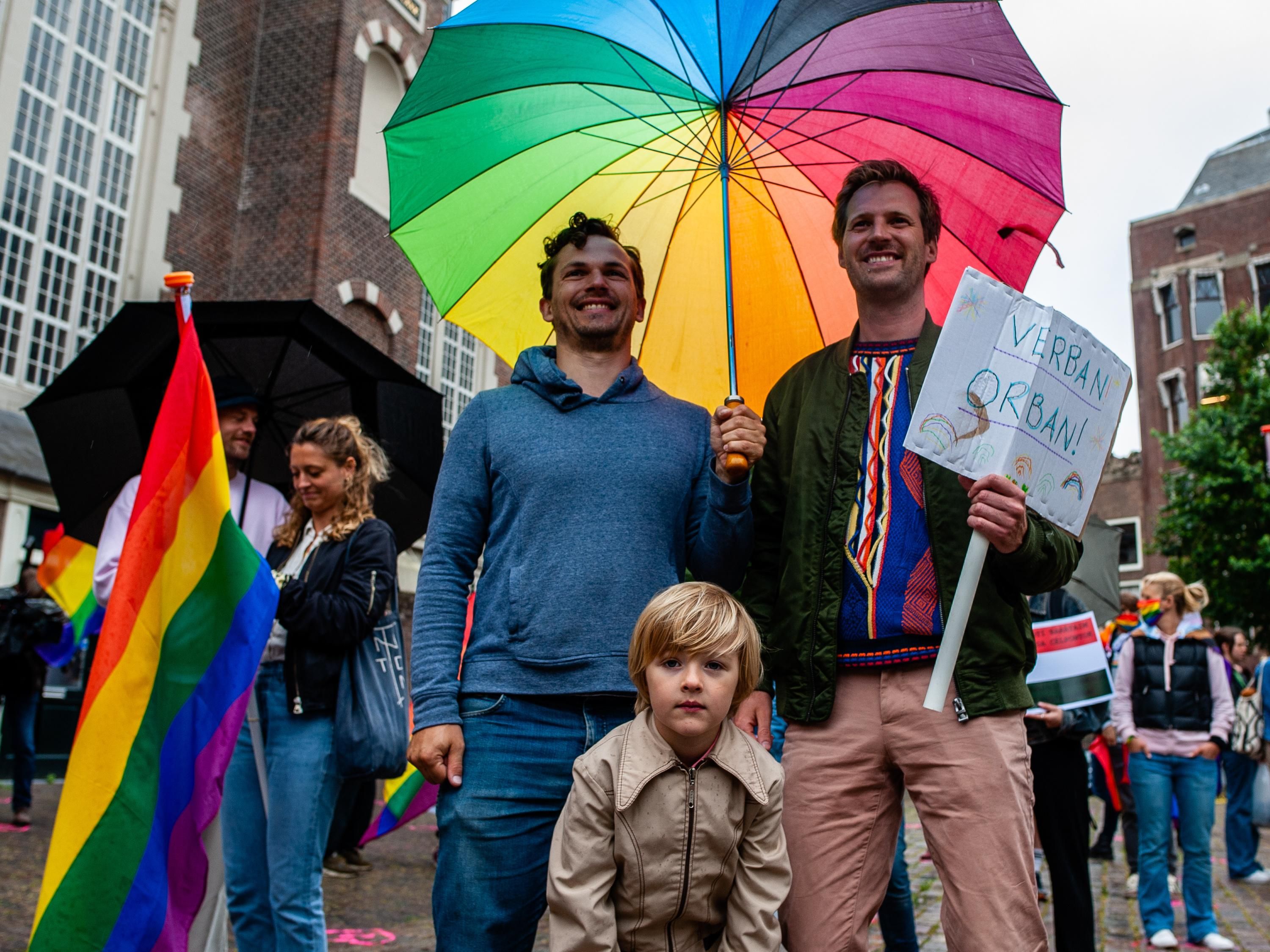 Two fathers with their child at a LGBTQ rights rally in Amsterdam