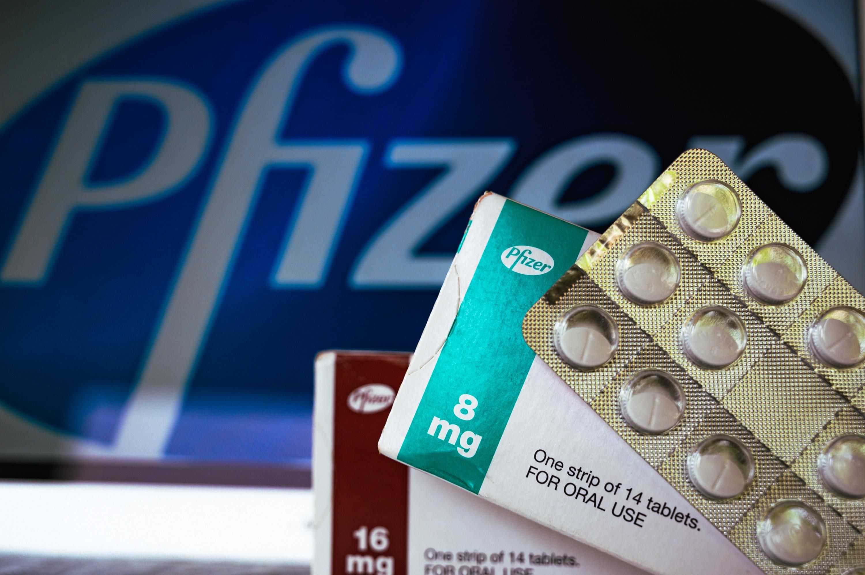 Pfizer logo with pills