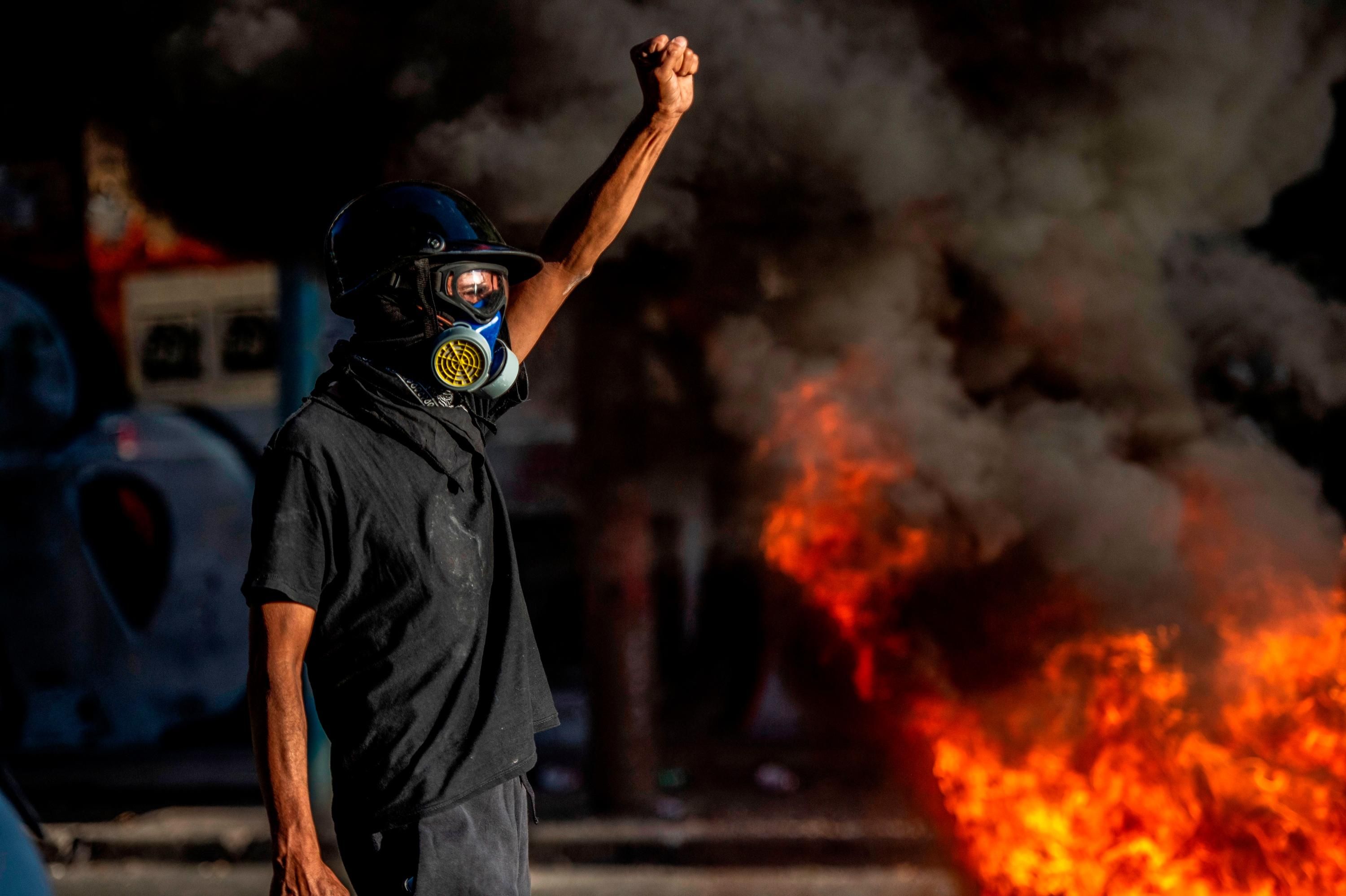 A demonstrator raises his fist in Chile