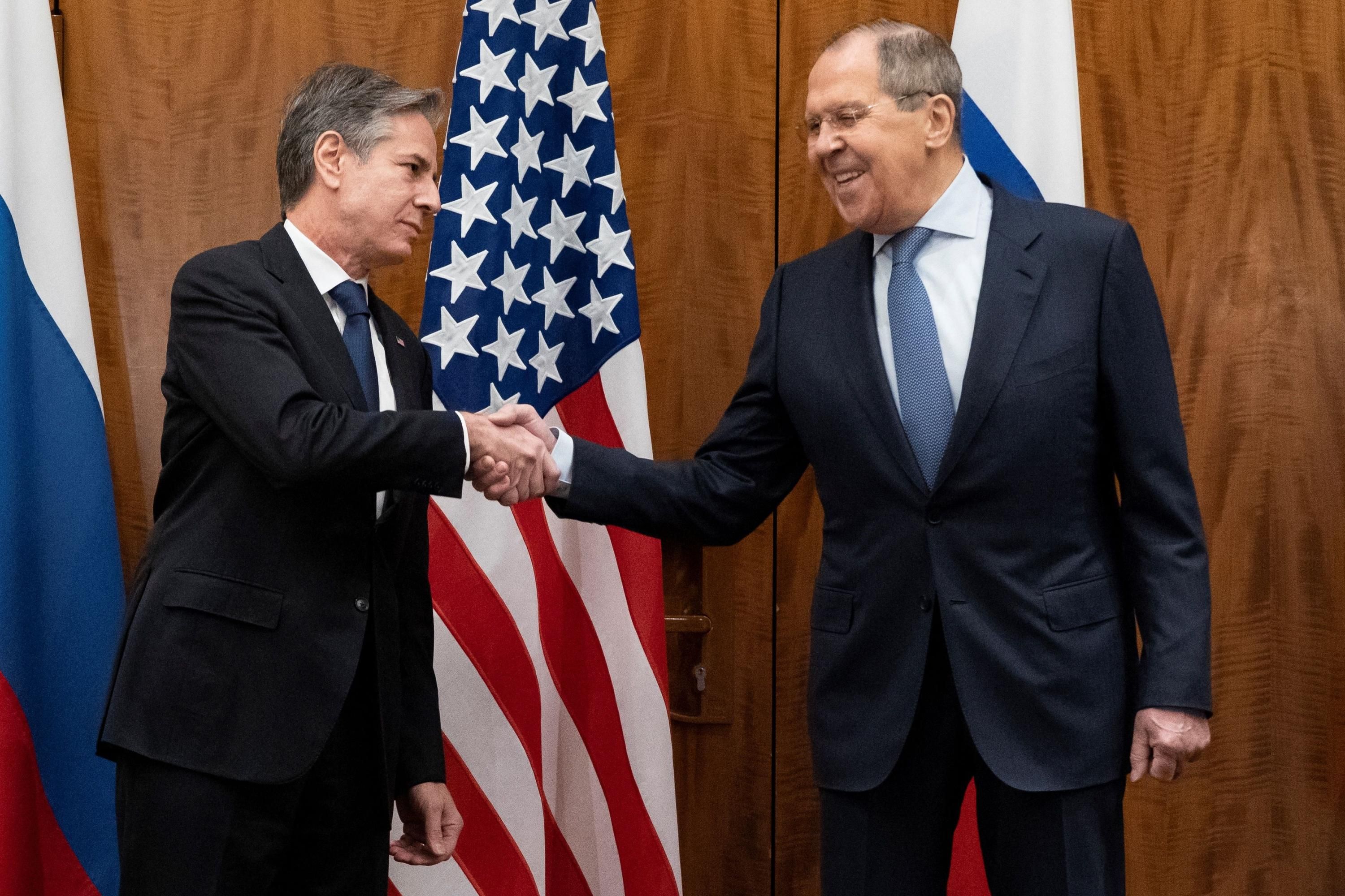 U.S. Secretary of State Antony Blinken and Russian Foreign Minister Sergey Lavrov shake hands.