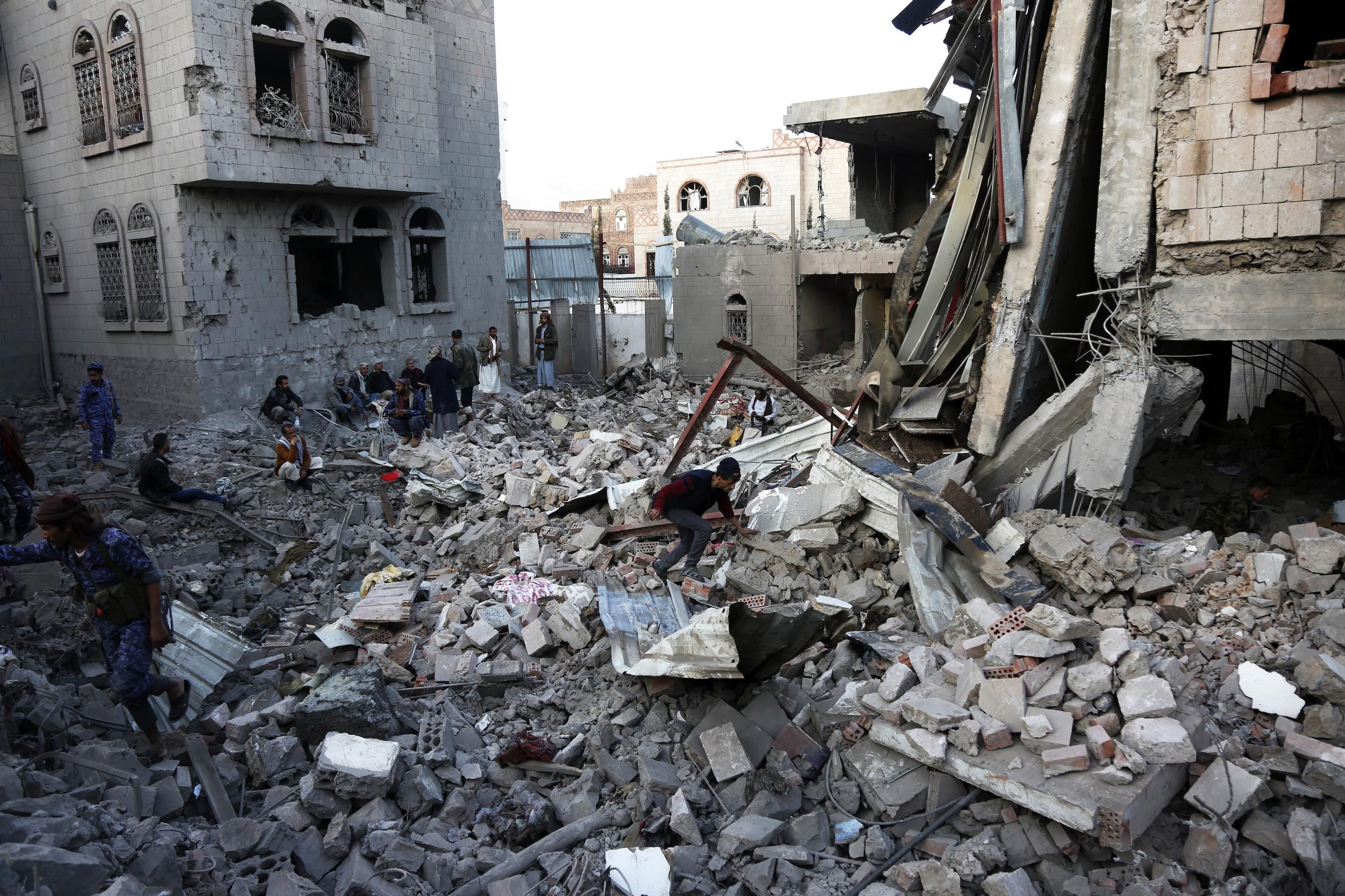 Yemenis inspect the scene of aerial attacks said to be carried out by aircraft of the coalition led by Saudi Arabia on January 18, 2022 in Sana'a, Yemen.