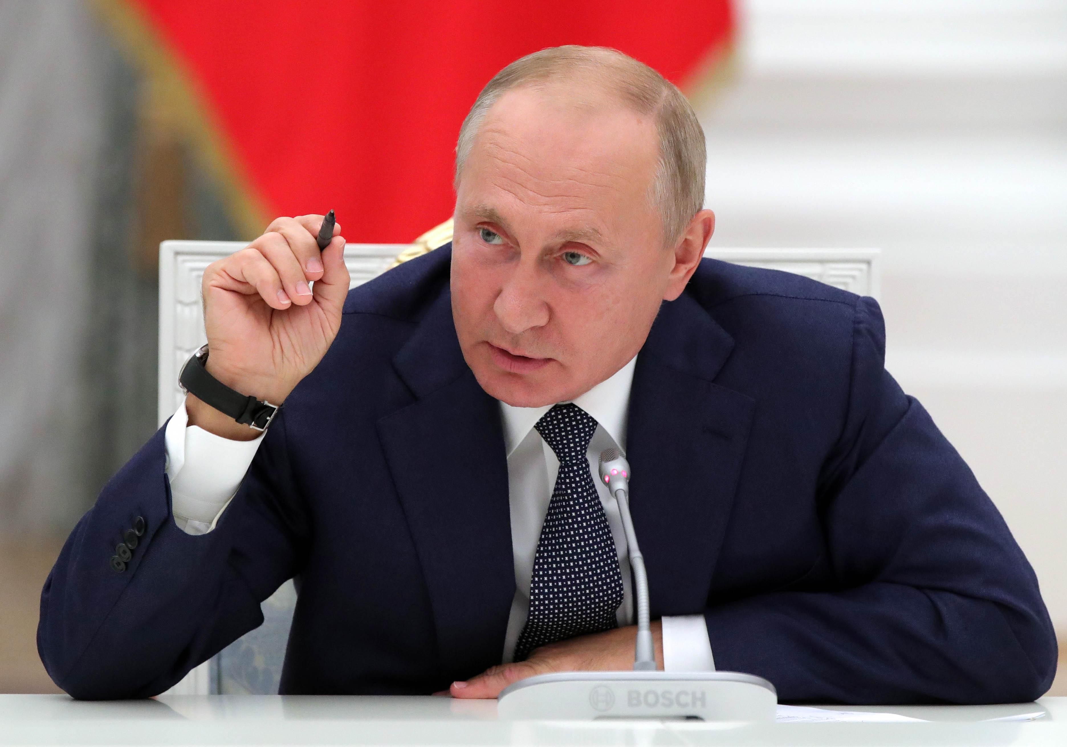 Russian President Vladimir Putin speaks with nuclear industry workers during a meeting on September 23, 2020 to mark the 75th anniversary of the country's nuclear industry at the Kremlin in Moscow. 