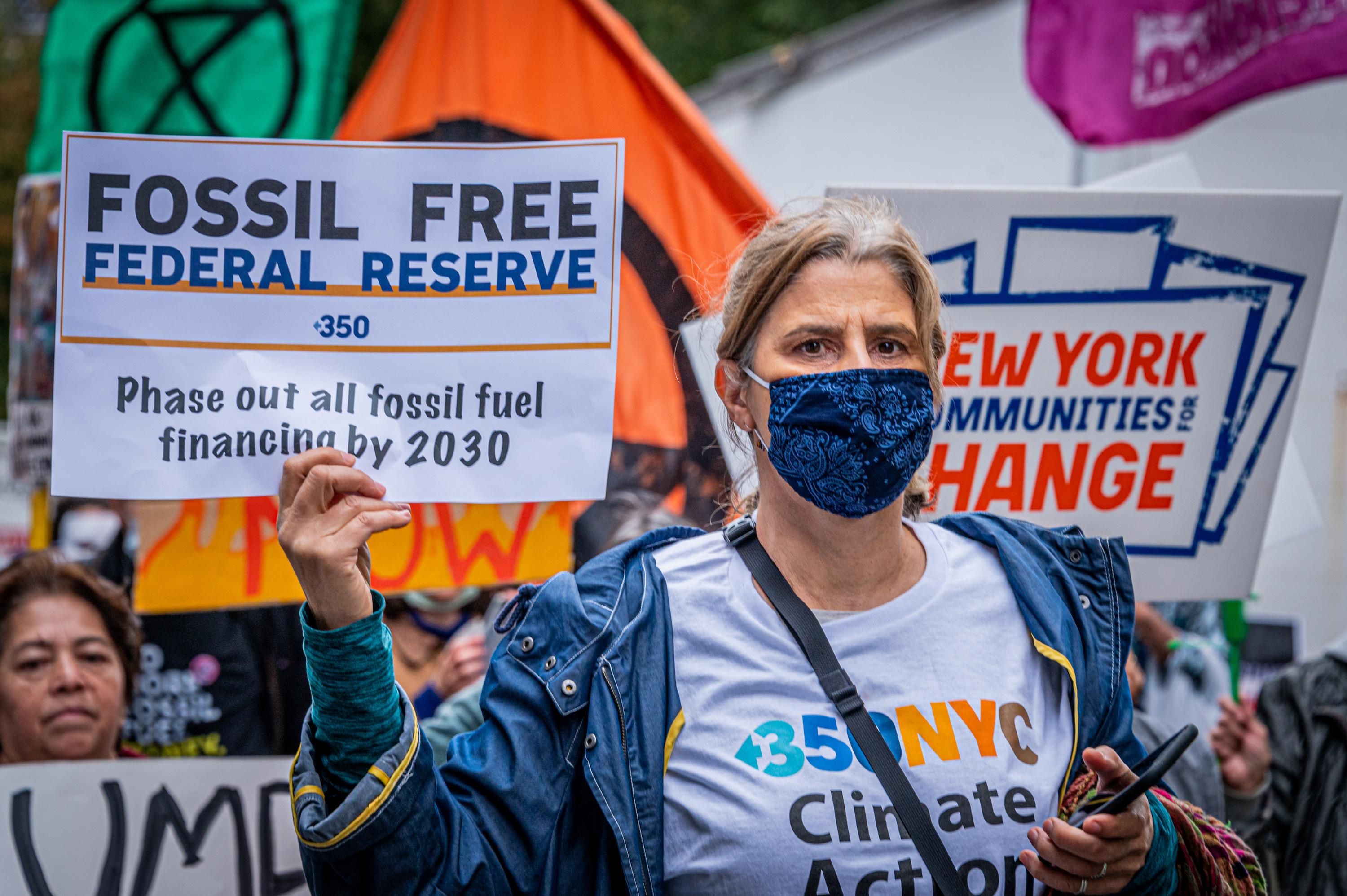 Climate protesters take part in an October 29, 2021 demonstration in New York City urging financial institutions to stop the pipeline of money flowing to the fossil fuel industry. (Photo: Erik McGregor/LightRocket via Getty Images)
