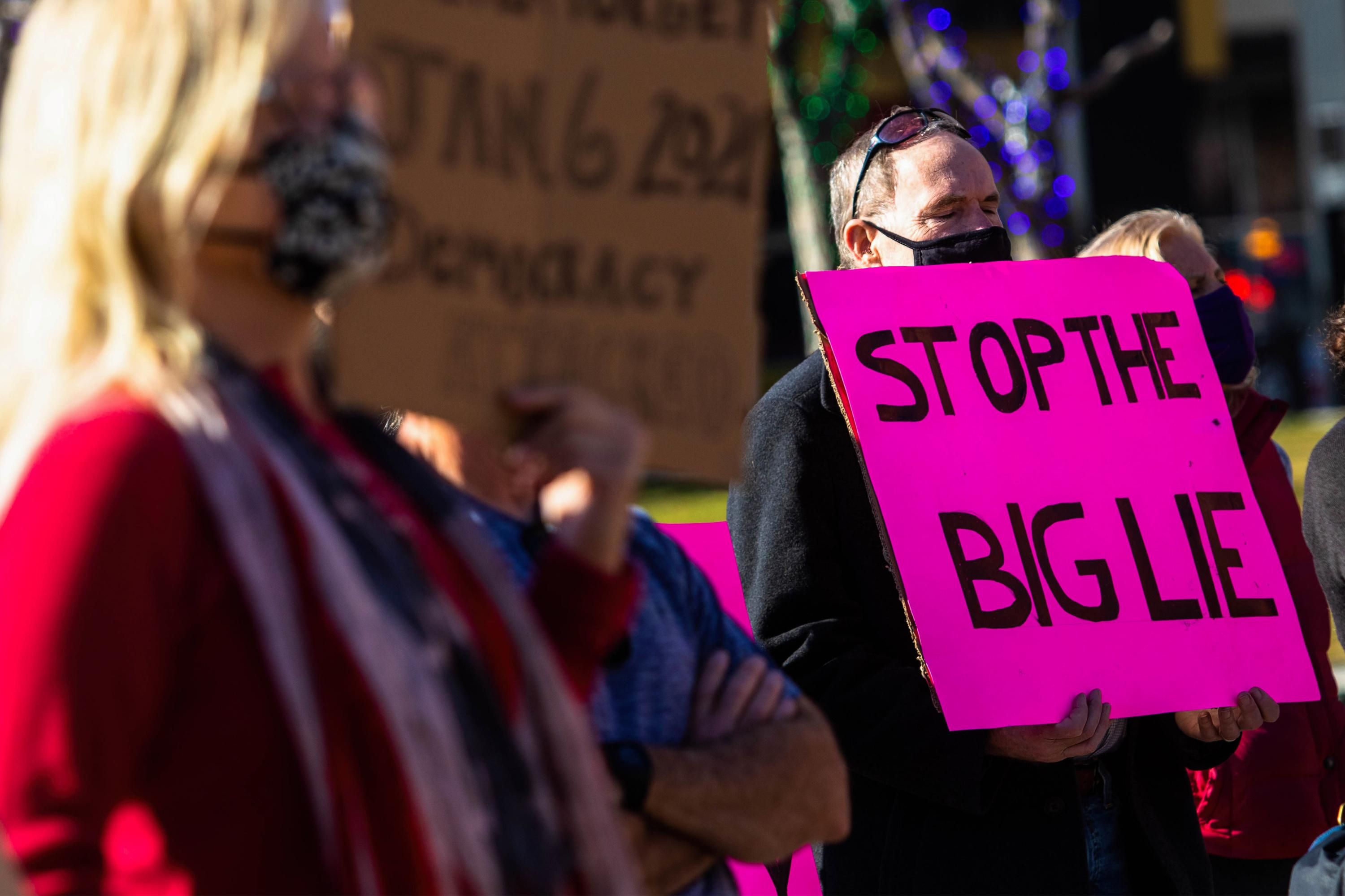 Demonstrators hold signs during a protest in Nevada