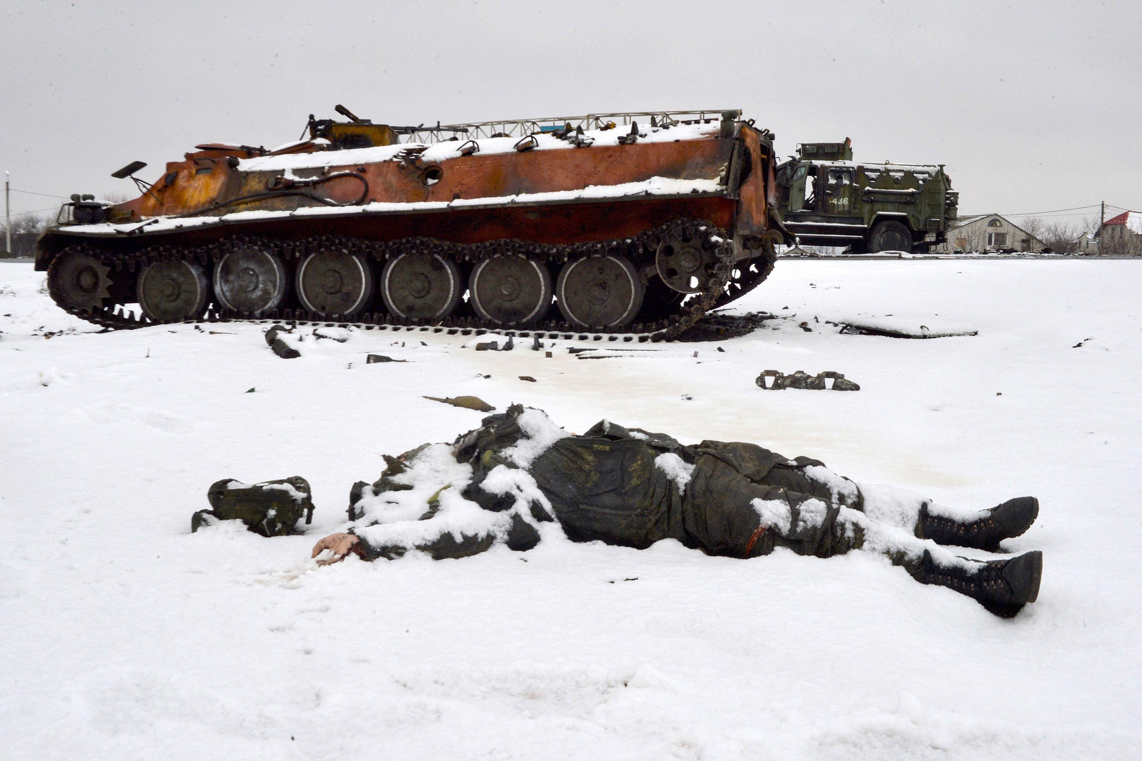 The body of a dead Russian soldier lies near destroyed military vehicles on the outskirts of Kharkiv, Ukraine on February 26, 2022.