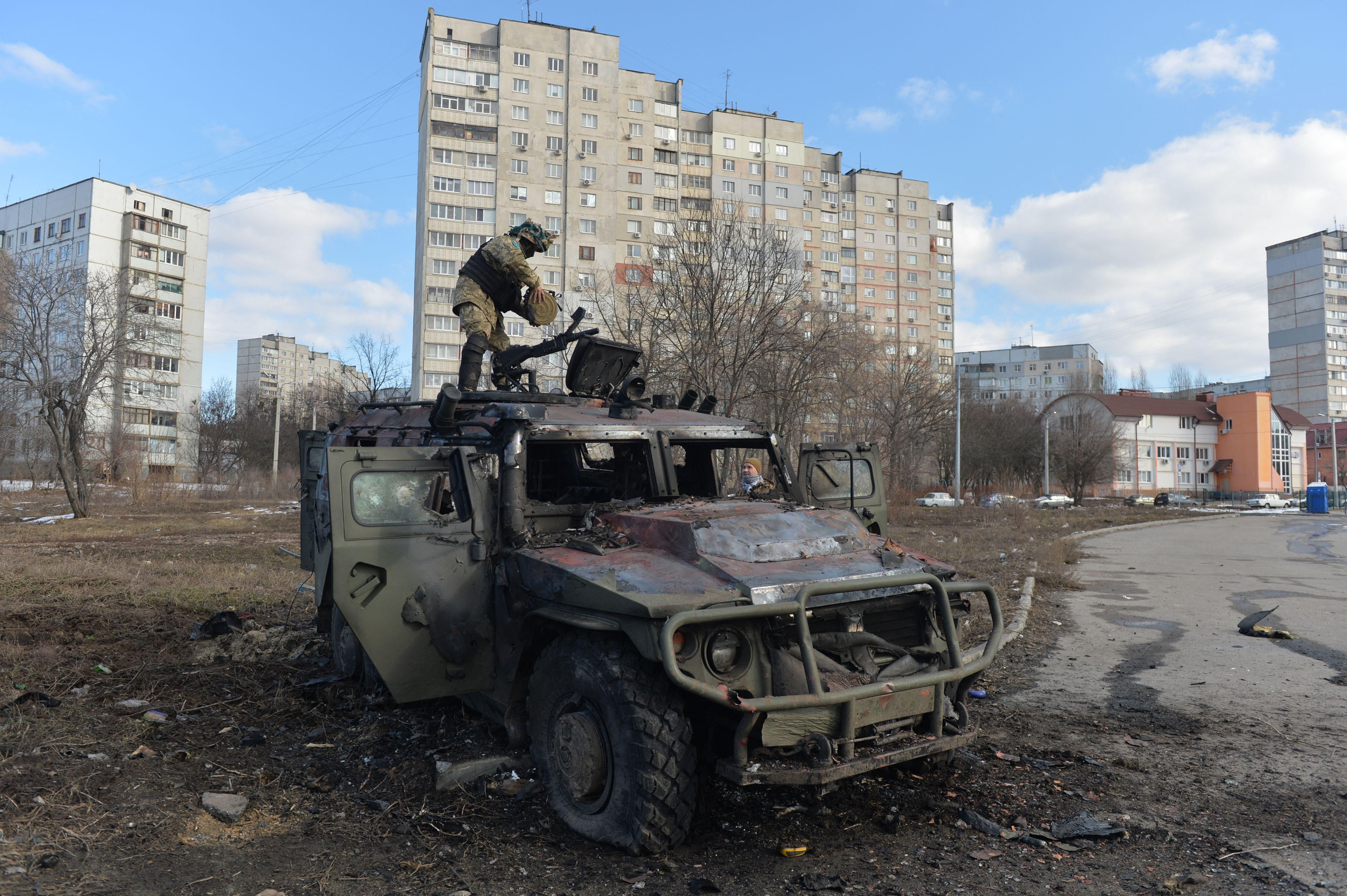 A Ukrainian soldier examines a destroyed Russian infantry mobility vehicle after fighting in Kharkiv, Ukraine on February 27, 2022.