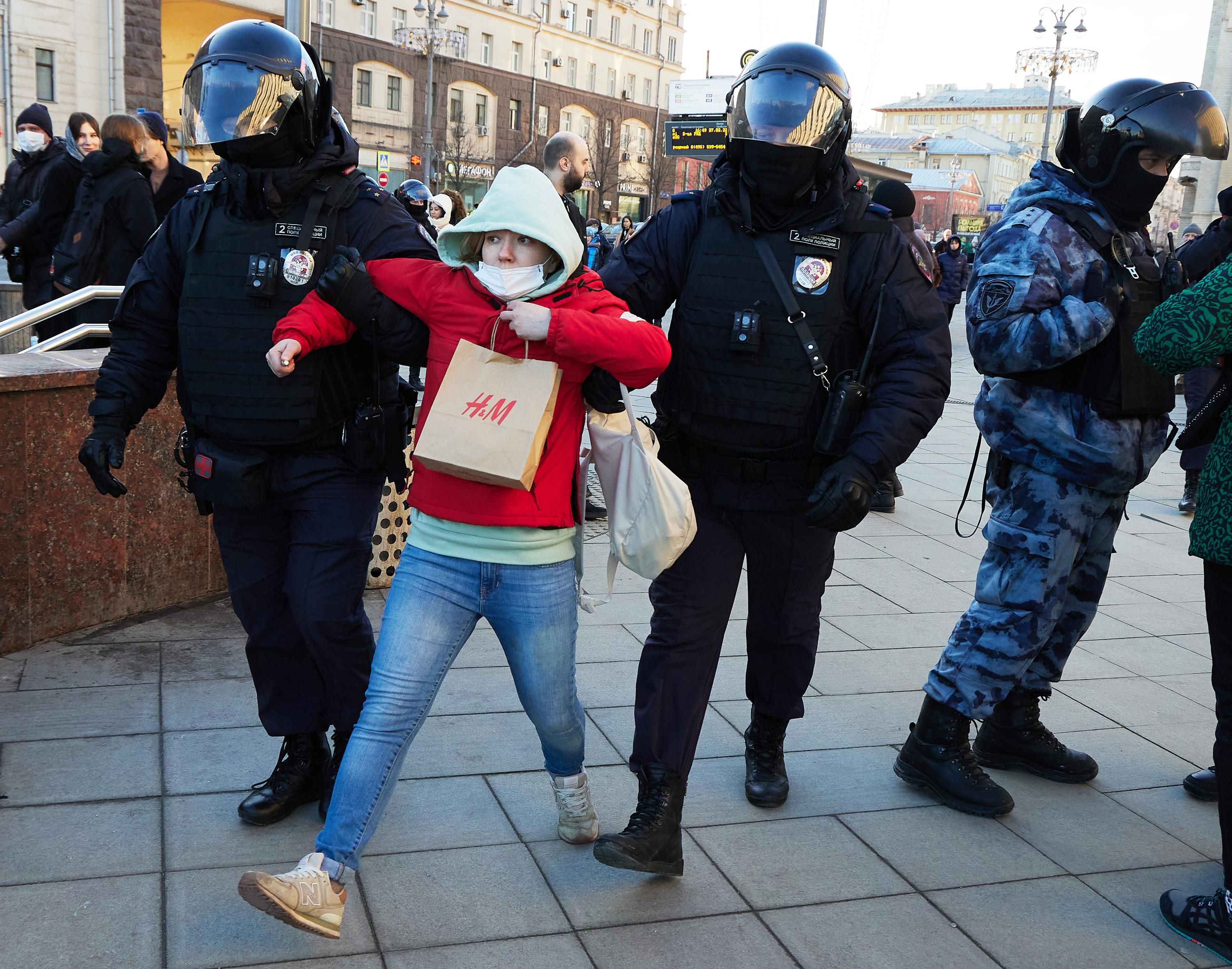 Police officers detain a woman during a protest against Russia's invasion of Ukraine at Pushkinskaya square on February 27, 2022 in Moscow, Russia.
