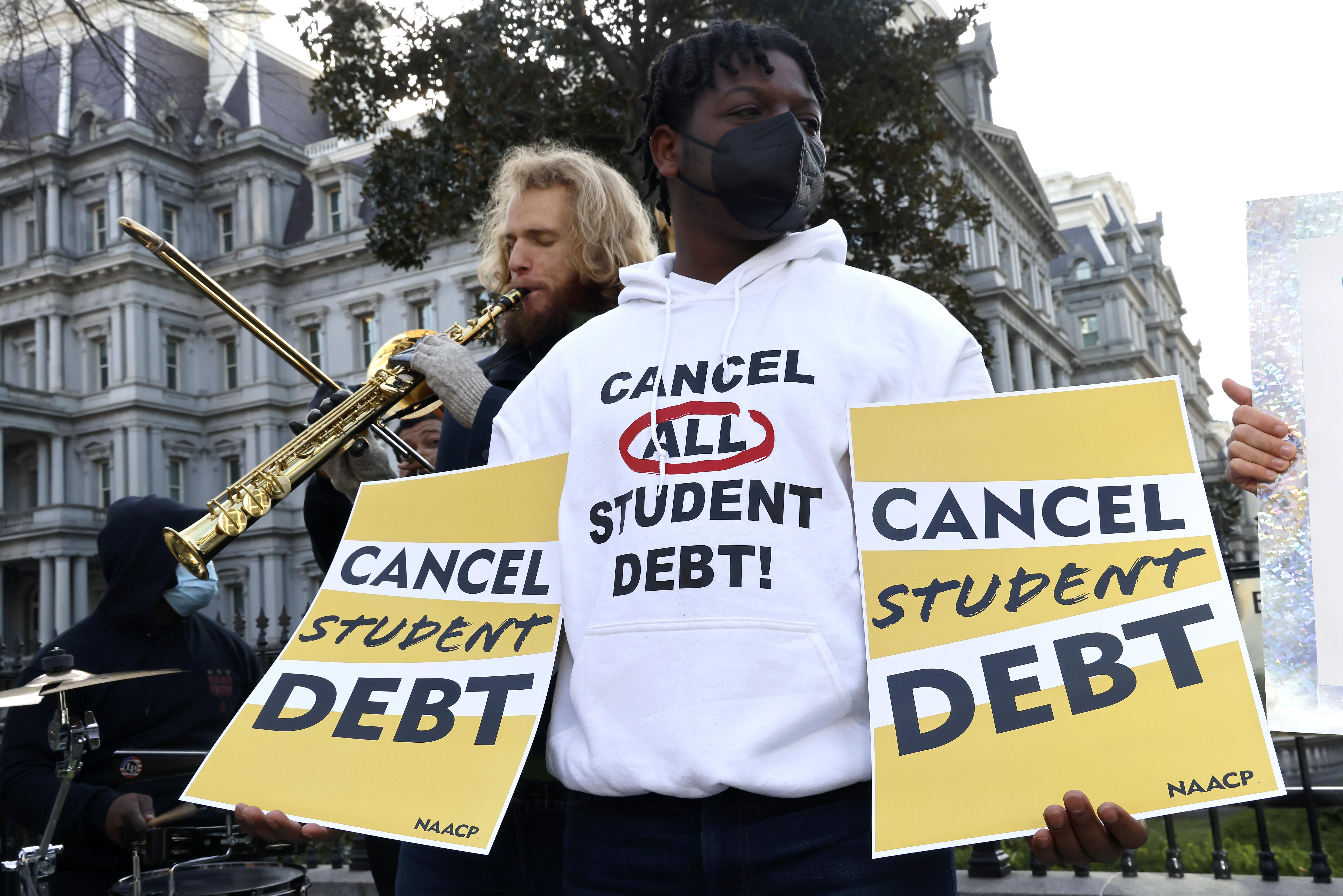 Student loan borrowers and the Too Much Talent Band thank President Joe Biden and Vice President Kamala Harris for extending the student loan pause while demanding that they cancel student debt at a gathering outside the White House on January 13, 2022, in Washington, D.C. 