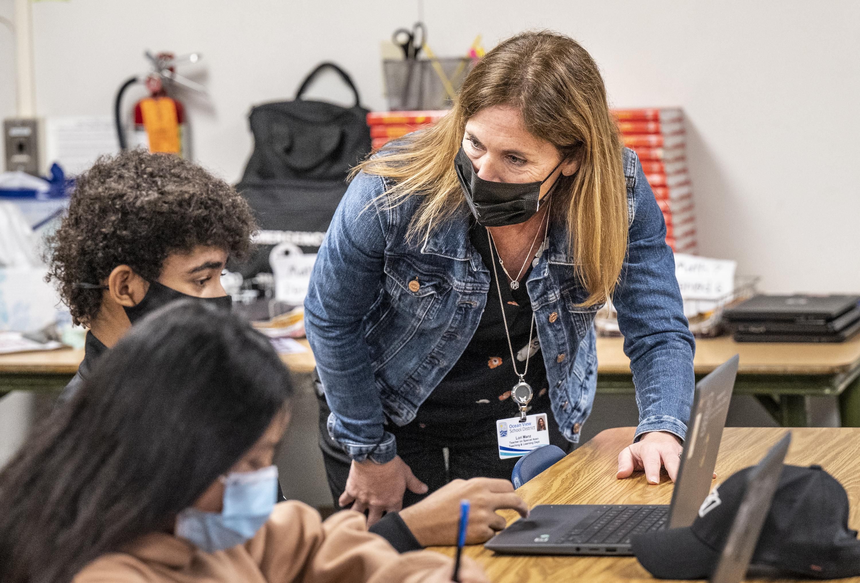 Lori Manz, who is normally a curriculum specialist in the Teaching and Learning Department at the Ocean View School District, substitute teaches in a 7th grade math class at Vista View Middle School in Huntington Beach, Calif. on Thursday, January 20, 2022.