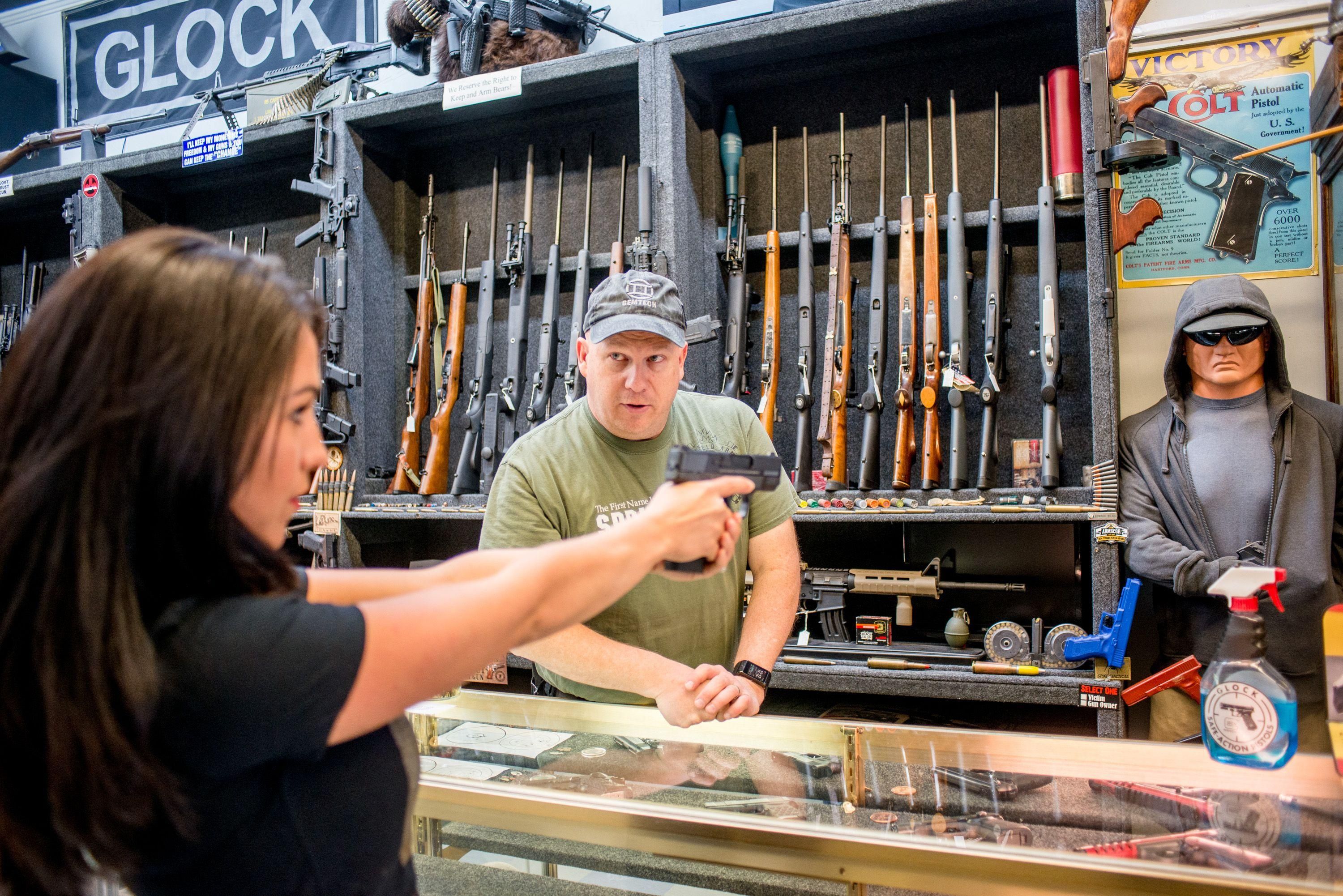 Rep. Lauren Boebert (R-Colo.) brandishes a firearm at a gun store in Rifle, Colorado on April 24, 2018.