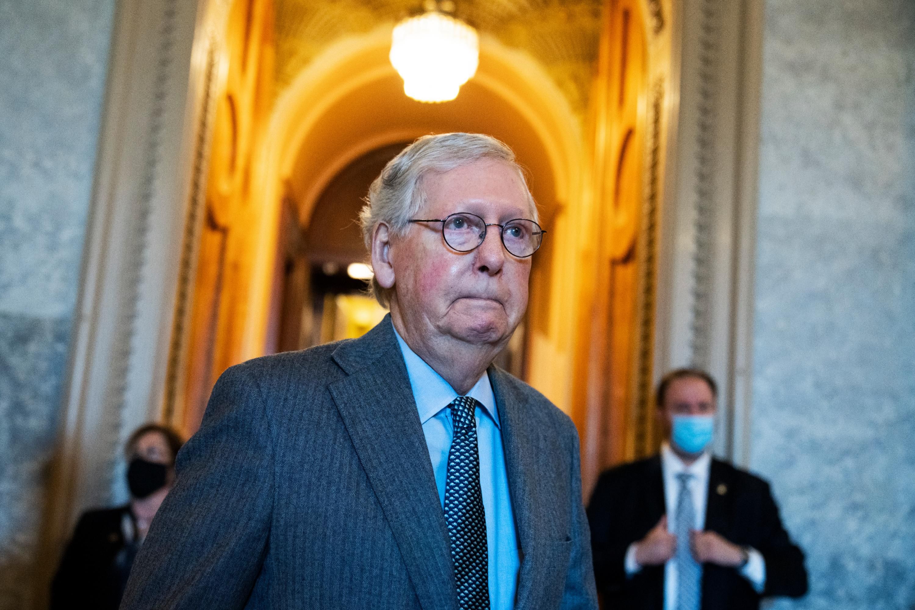 Senate Minority Leader Mitch McConnell walks through the halls of the Senate
