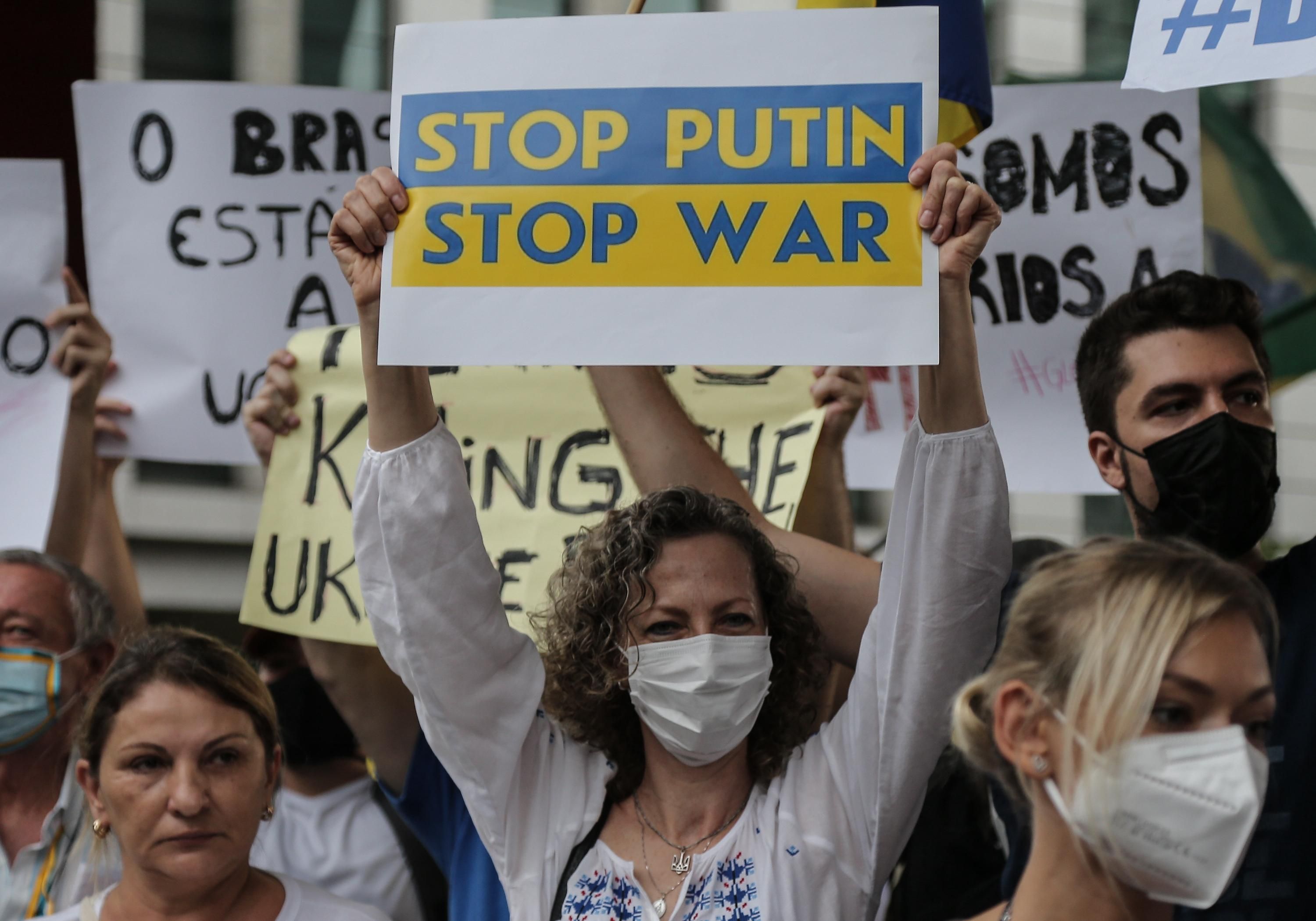 People hold banners during a demonstration in support of Ukraine at Paulista avenue in Sao Paulo, Brazil on March 1, 2022.
