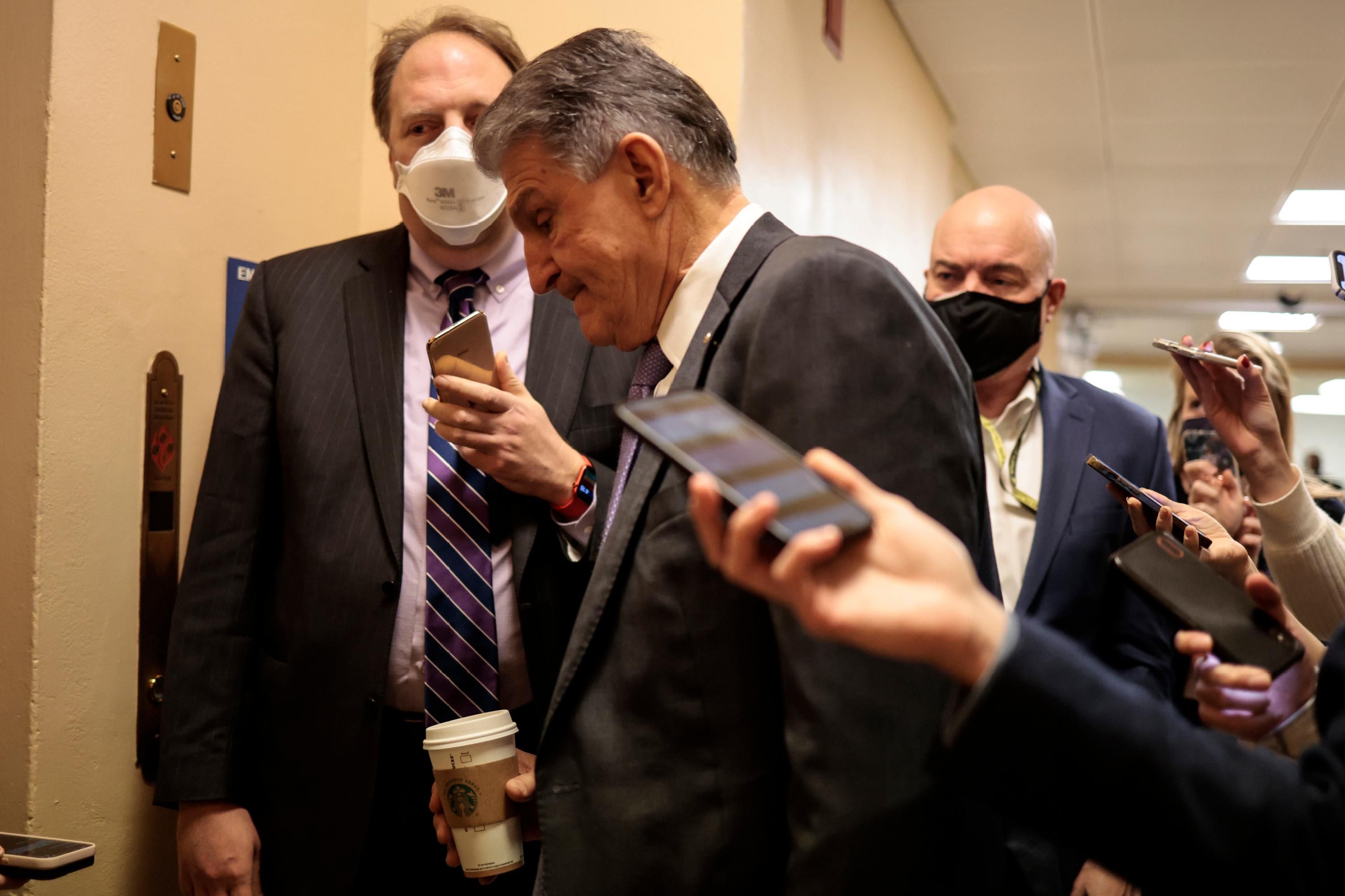Sen. Joe Manchin walks through the halls of Congress