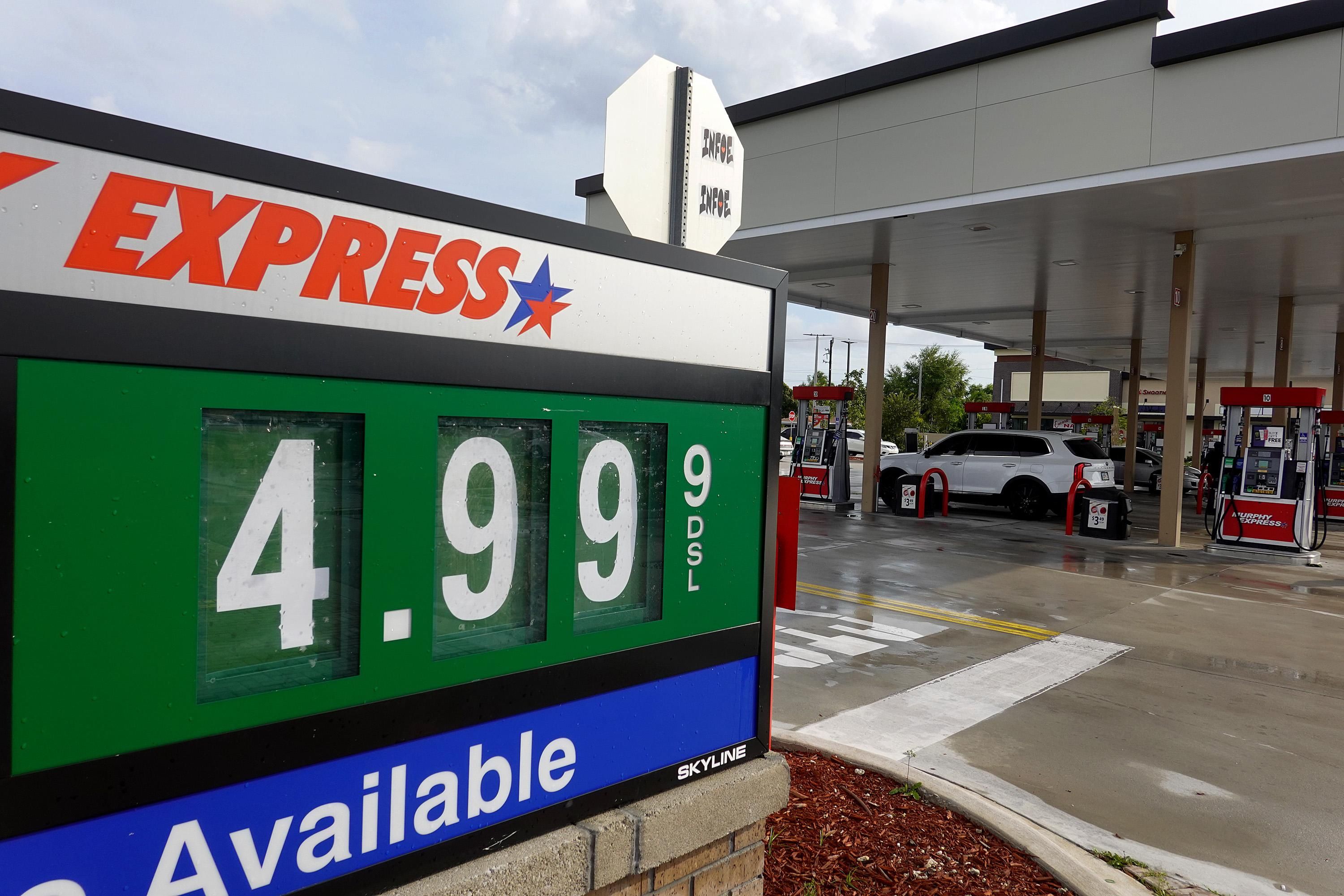A sign reflects the price per gallon of fuel at a gas station on March 10, 2022 in Miami.