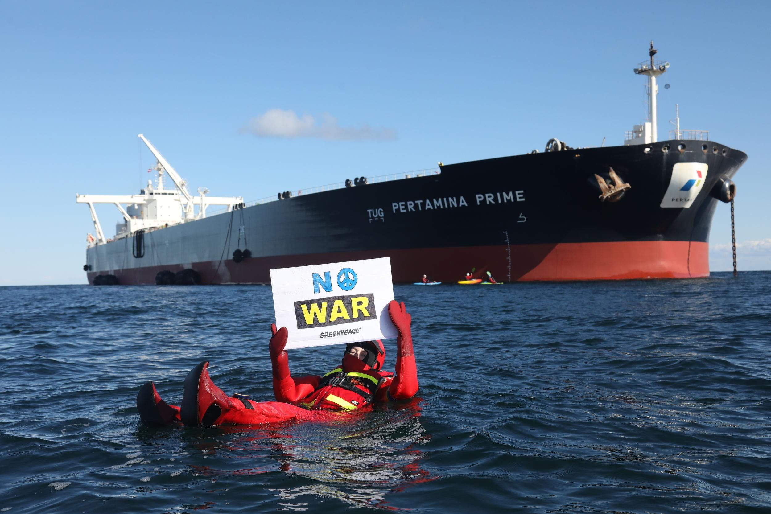 Swimmers and kayakers attempt to block a Russian tanker transporting oil in Danish waters on March 31, 2022.