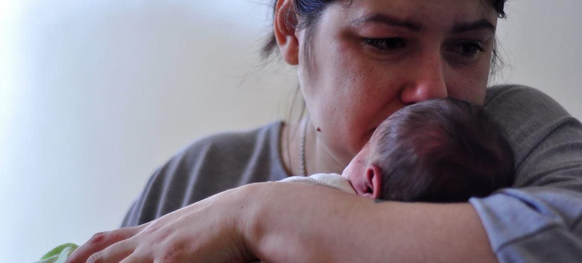 A Ukrainian mother holds her child