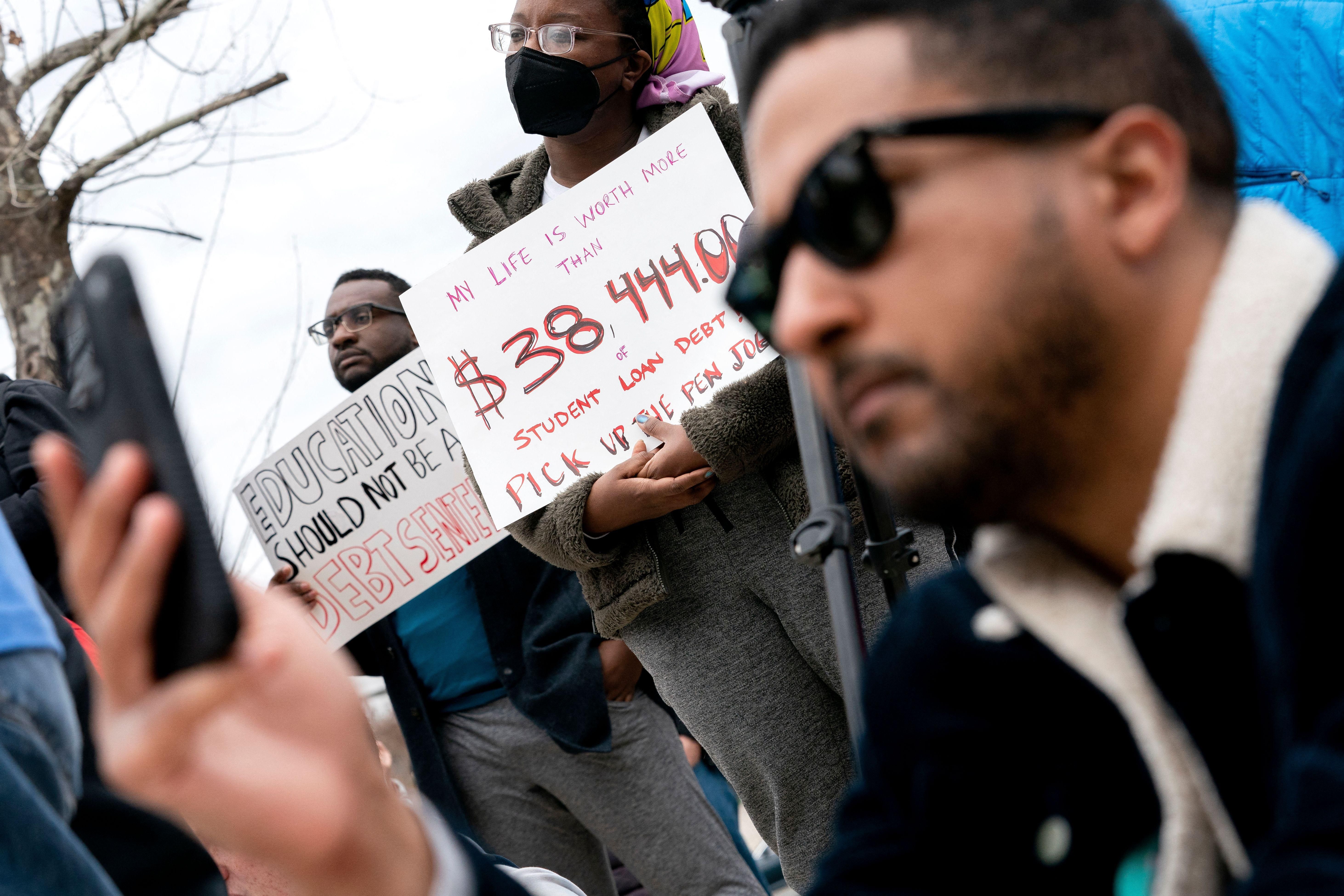 People attend a rally to urge the Biden administration to cancel all federal student loan debt in Washington, D.C. on April 4, 2022.