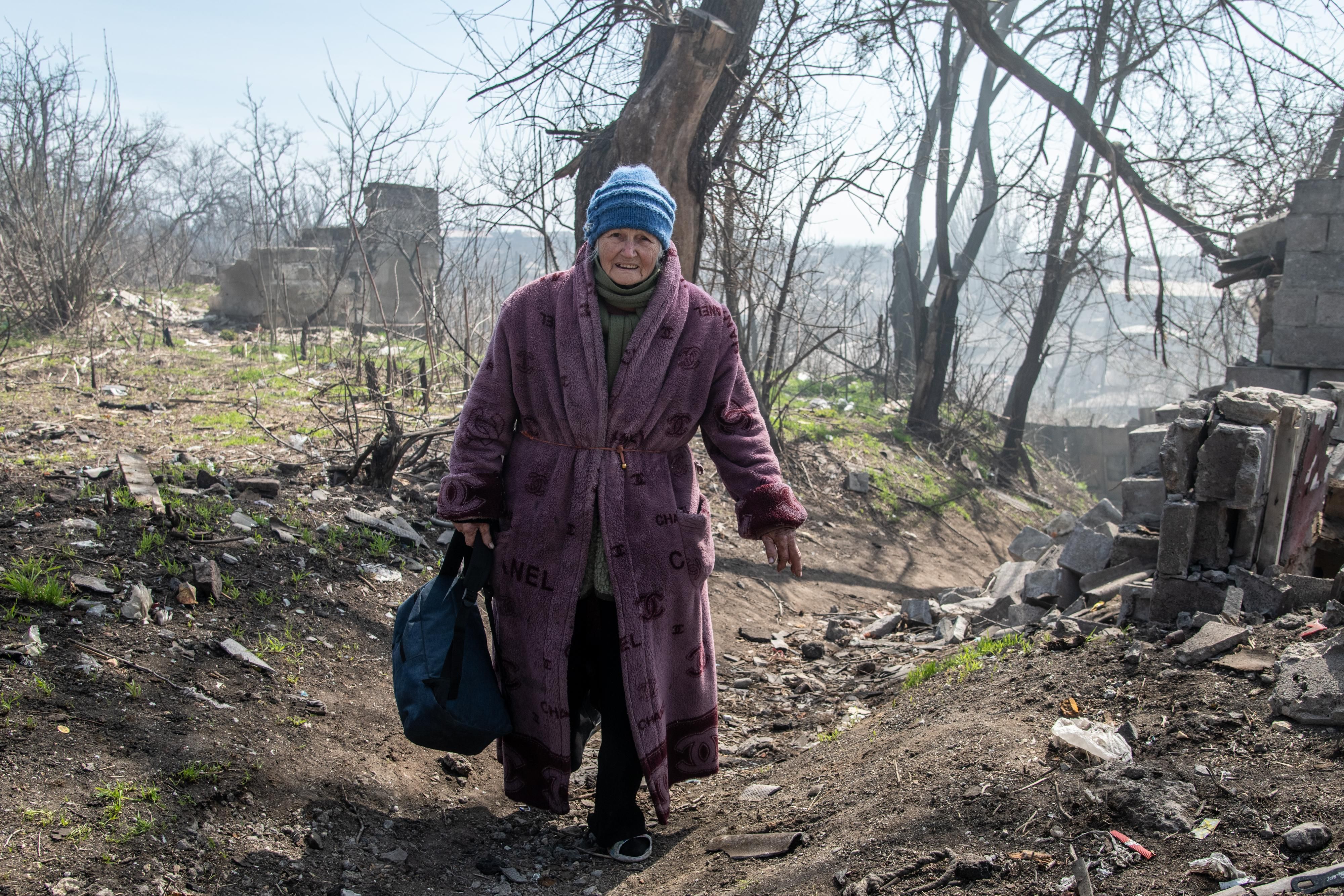 A woman walks on a hill leading down to the Azov Sea in the southern area of Mariupol, Ukraine on April 9, 2022.