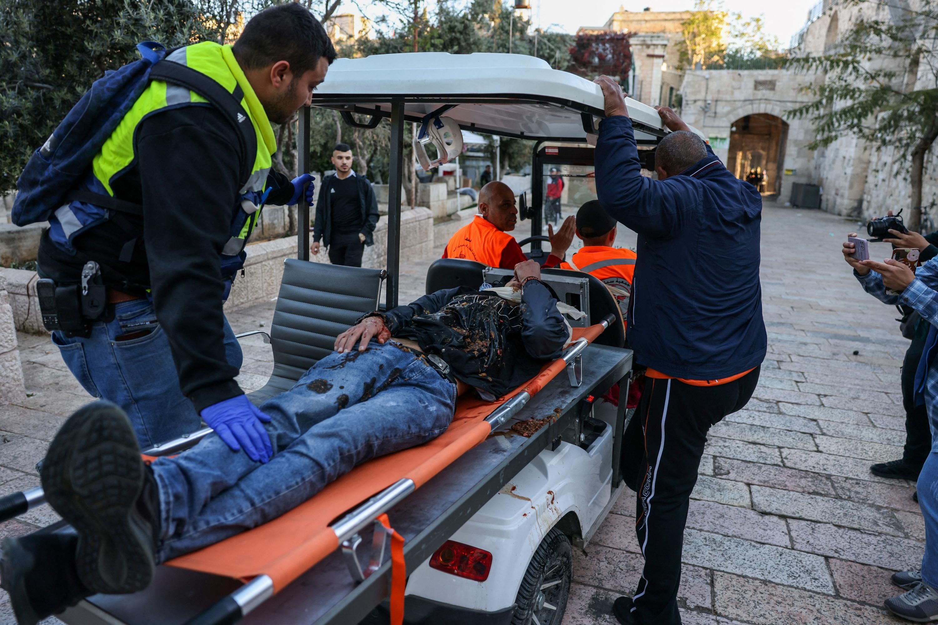 Medics transport an injured Palestinian man to the hospital