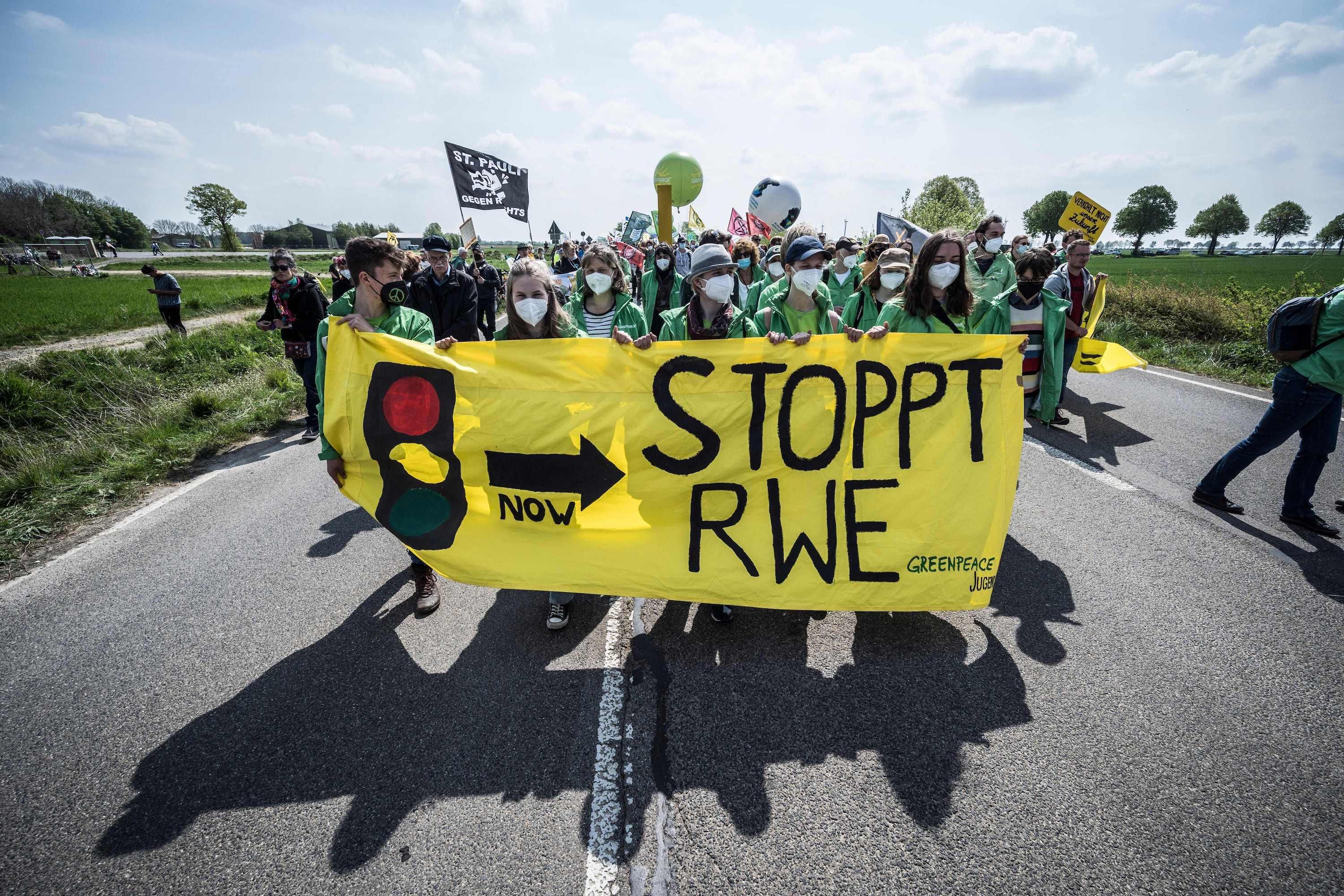 People take part in a protest against the destruction of a village for the expansion of the Garzweiler lignite open cast mine near Lützerath, western Germany, on April 23, 2022. German energy provider RWE is planning to entirely demolish houses in the village of Lützerath for coal mining. (Photo: Bernd Lauter/AFP via Getty Images)