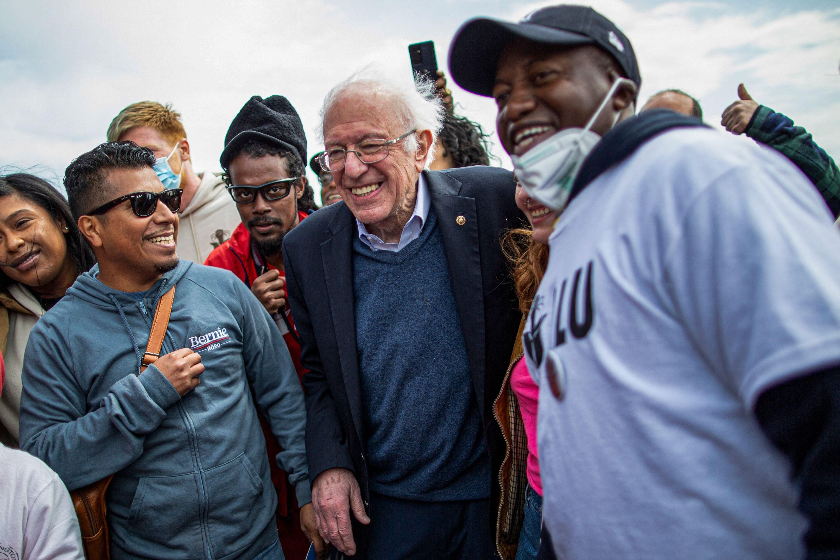 Sen. Bernie Sanders (I-Vt.) walks with Amazon workers during a rally outside one of the company's buildings in New York City on April 24, 2022. 
