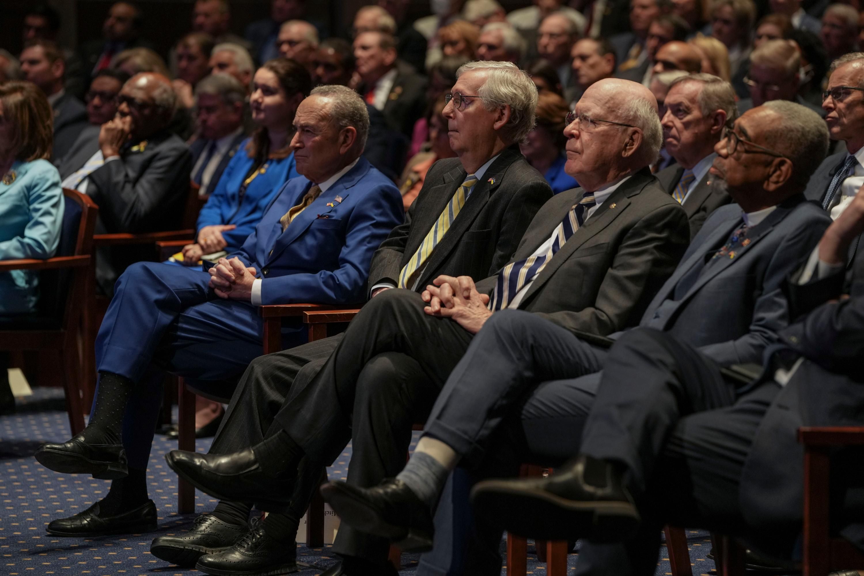 Senate Majority Leader Chuck Schumer and Minority Leader Mitch McConnell watch a speech