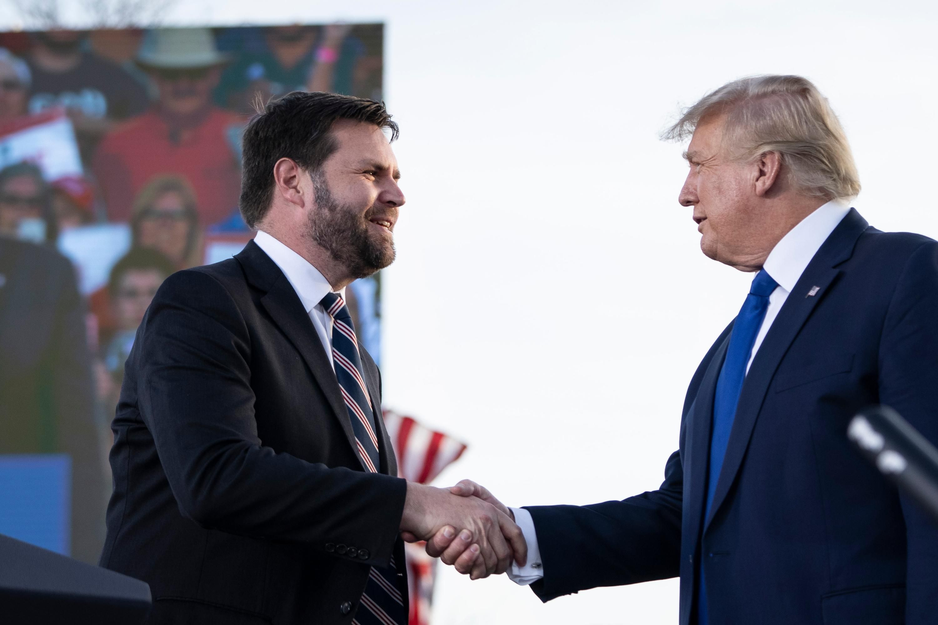 JD Vance shakes hands with Donald Trump