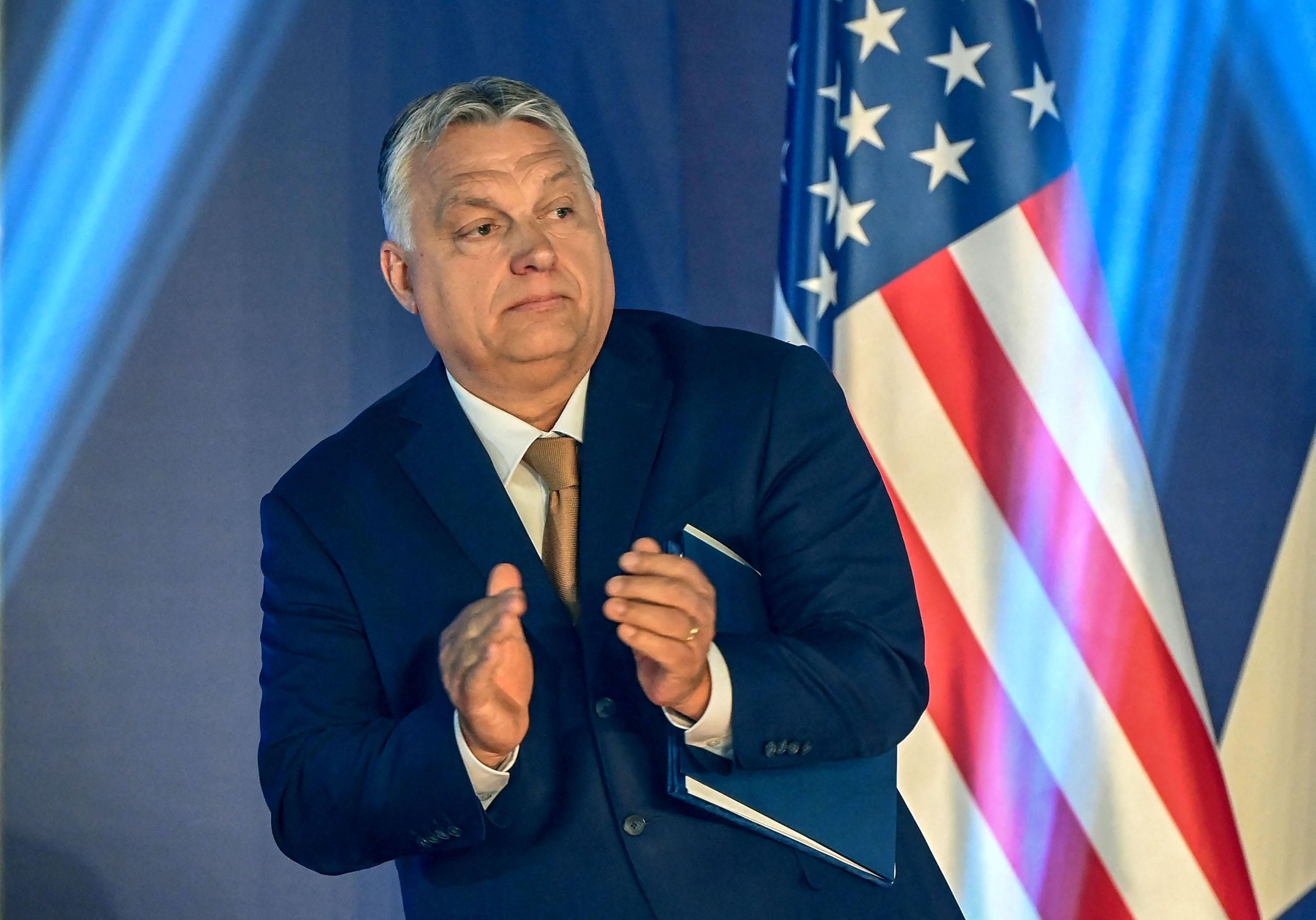 Hungarian Prime Minister Viktor Orban stands in front of a US flag after addressing a keynote speech during an extraordinary session of the Conservative Political Action Conference (CPAC) at the Balna cultural centre of Budapest, Hungary on May 19, 2022. - The two-day CPAC meeting is being held in Europe for the first time. (Photo by ATTILA KISBENEDEK/AFP via Getty Images)