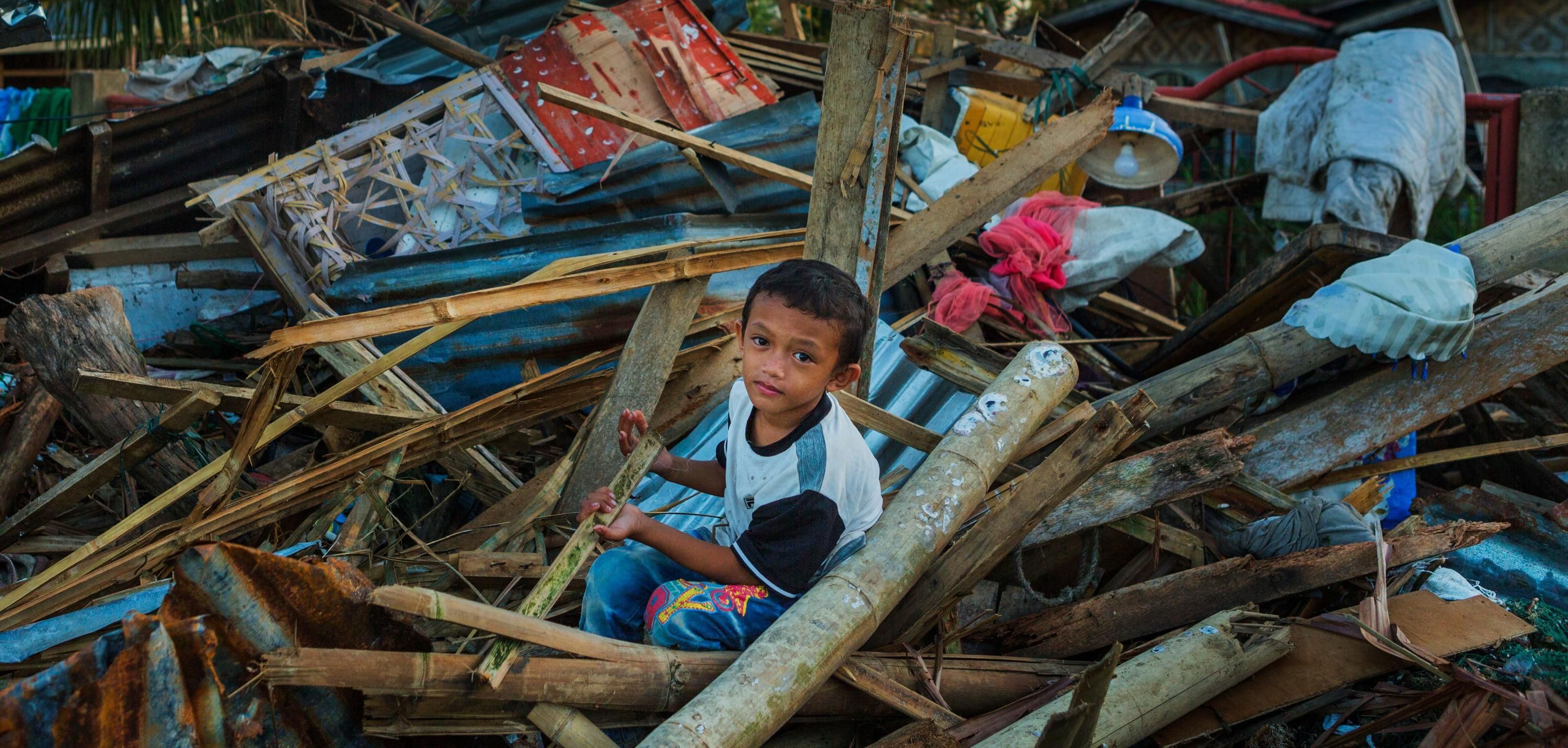 Child in typhoon debris